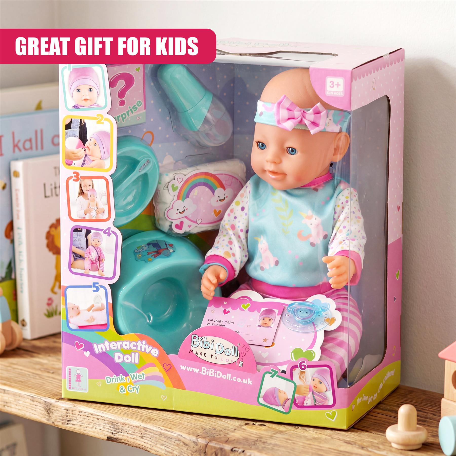 Boxed playset features a doll with accessories, including a bottle, basin, and rainbow blanket.