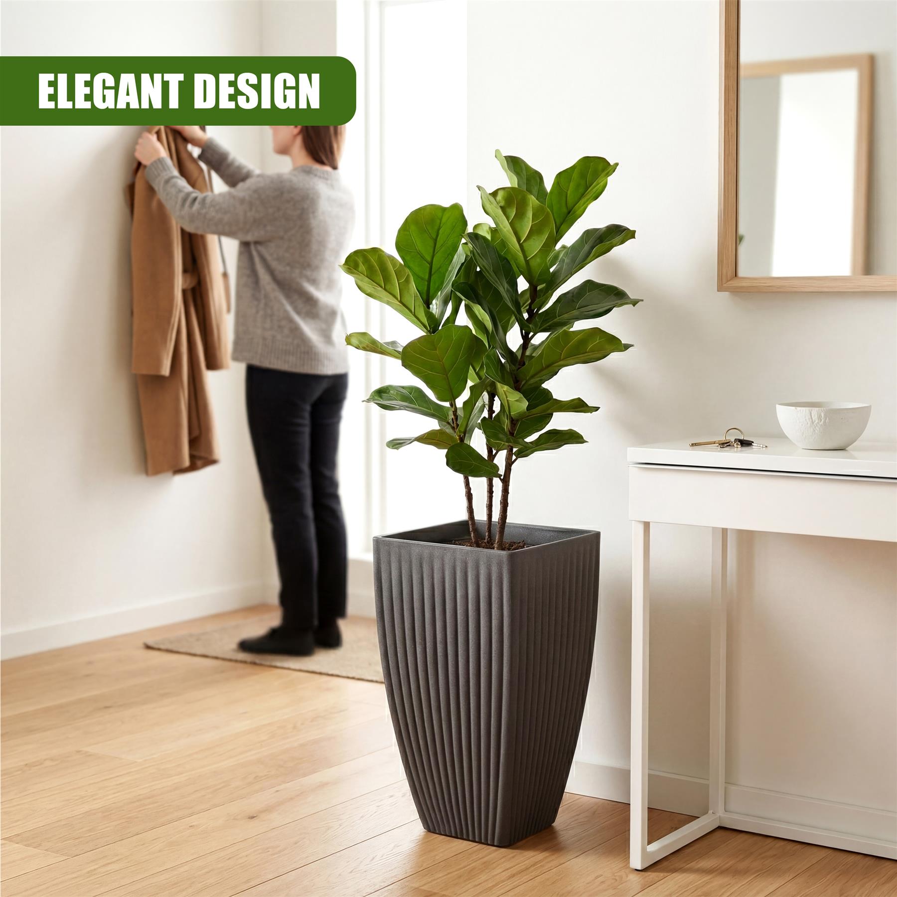A tall, gray planter pot with vertical grooves holds a lush, leafy green indoor plant.