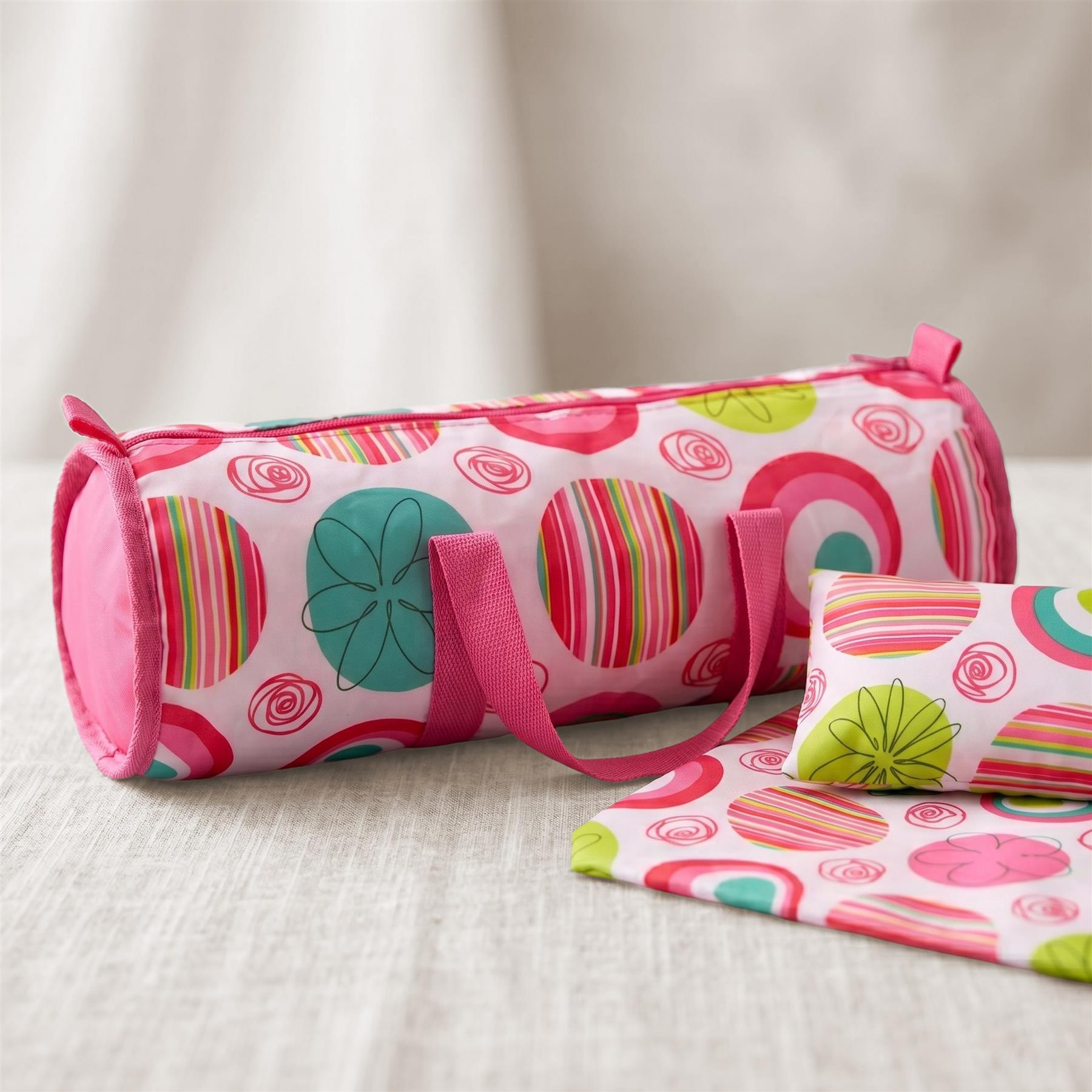 Colorful patterned travel bag with a pink strap, resting near matching striped textiles.
