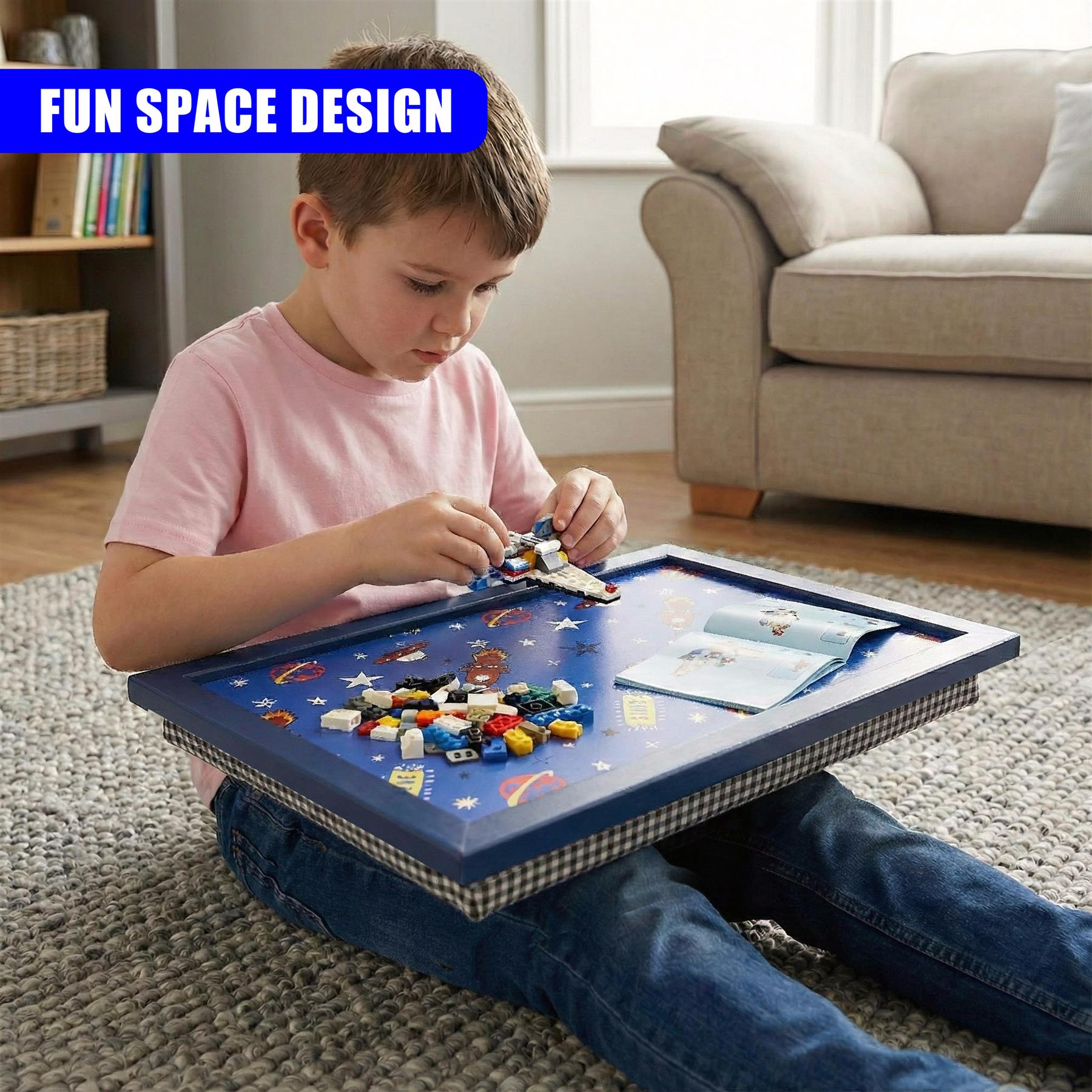 Boy playing with miniature space figures on a blue tray decorated with celestial planets and stars.