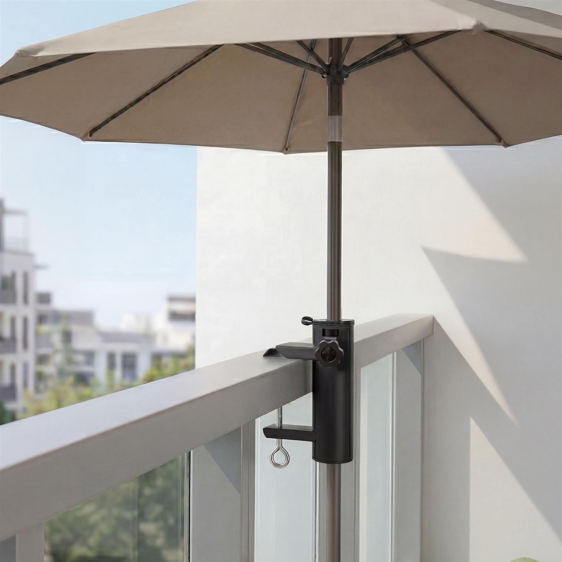 Black metal parasol clamp securing a pole to a modern, light gray balcony railing.