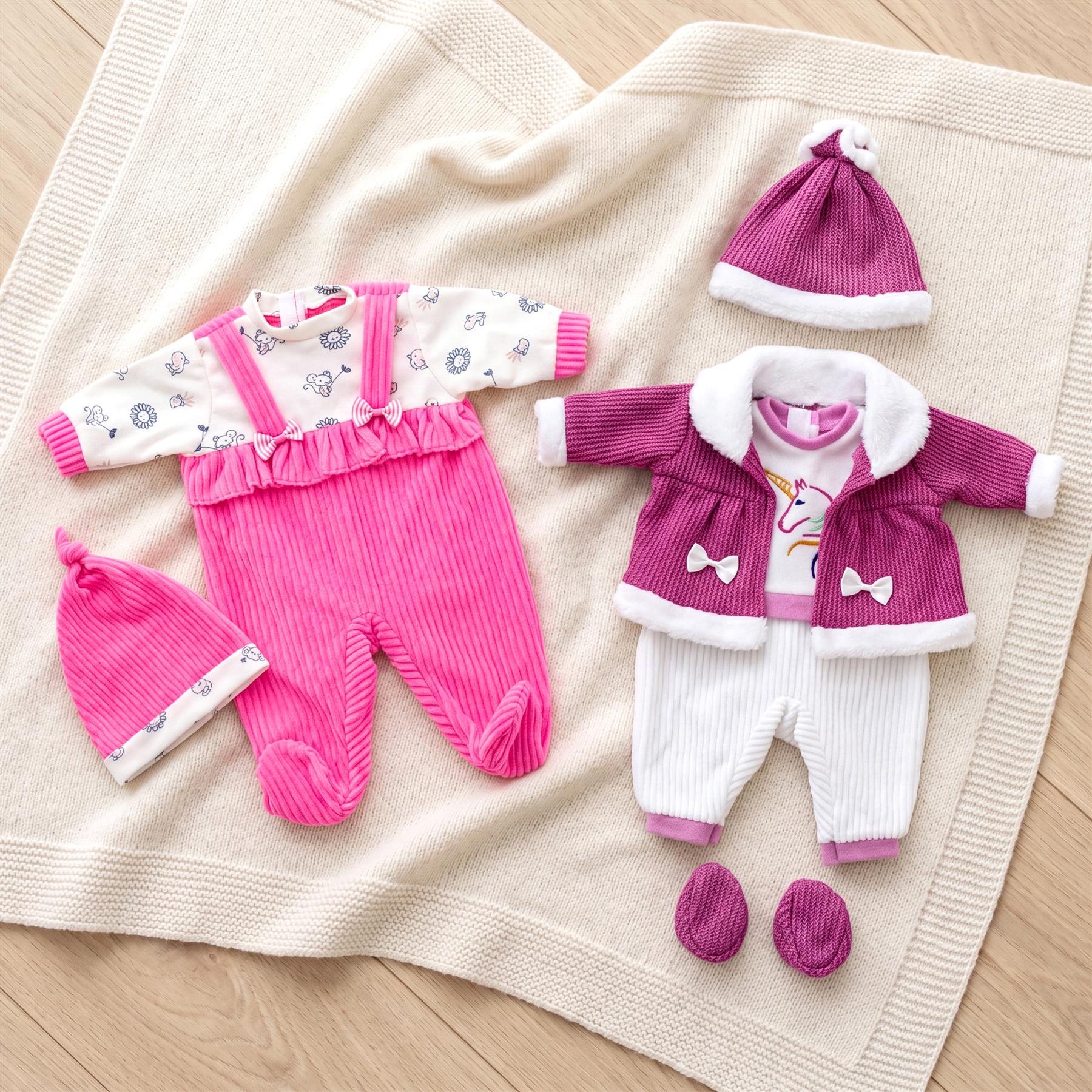 Pink and purple doll clothes sets, featuring coordinating tops, pants, coats, and hats.