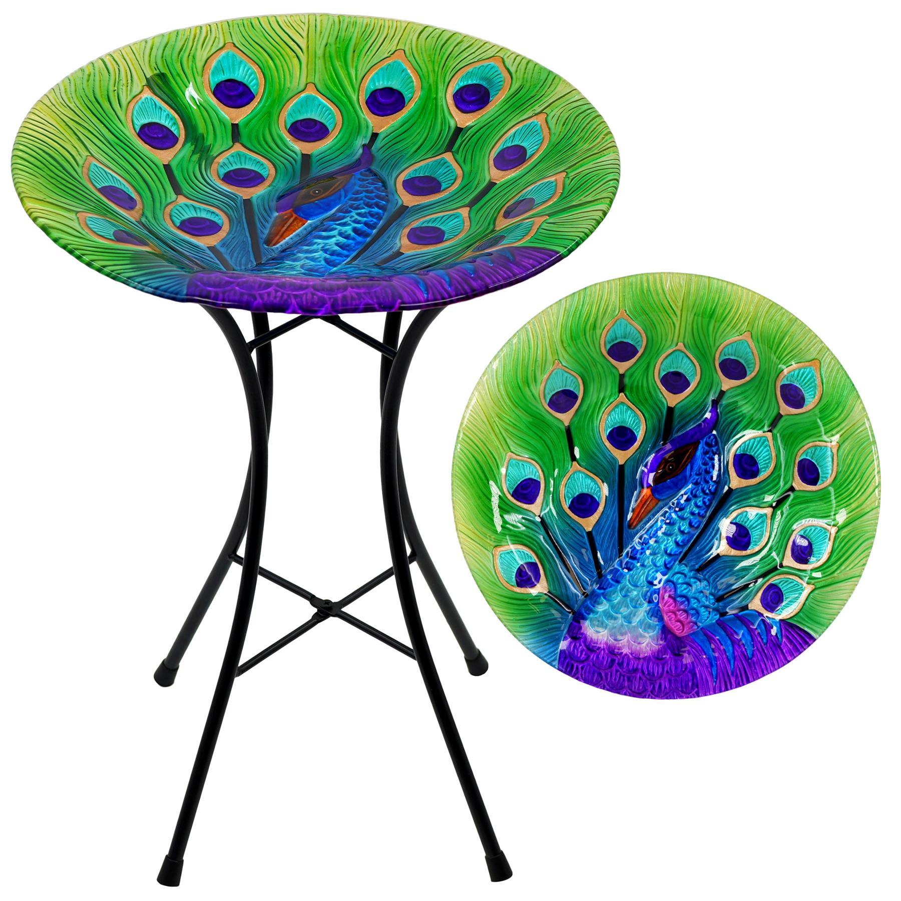 Round glass table with black metal legs painted with colorful peacock designs.