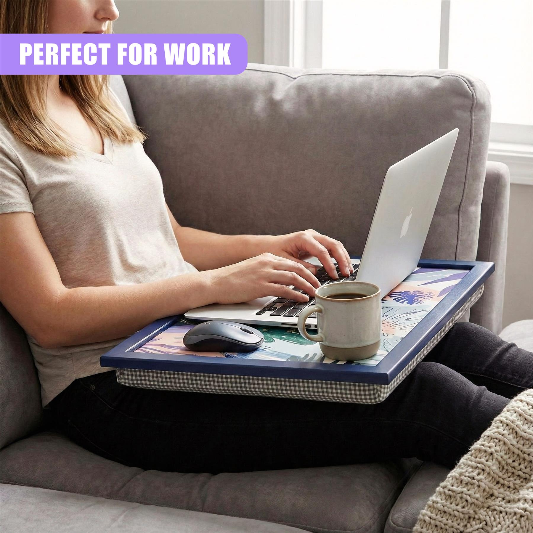 Woman uses lap tray cushion while working on laptop in an armchair.