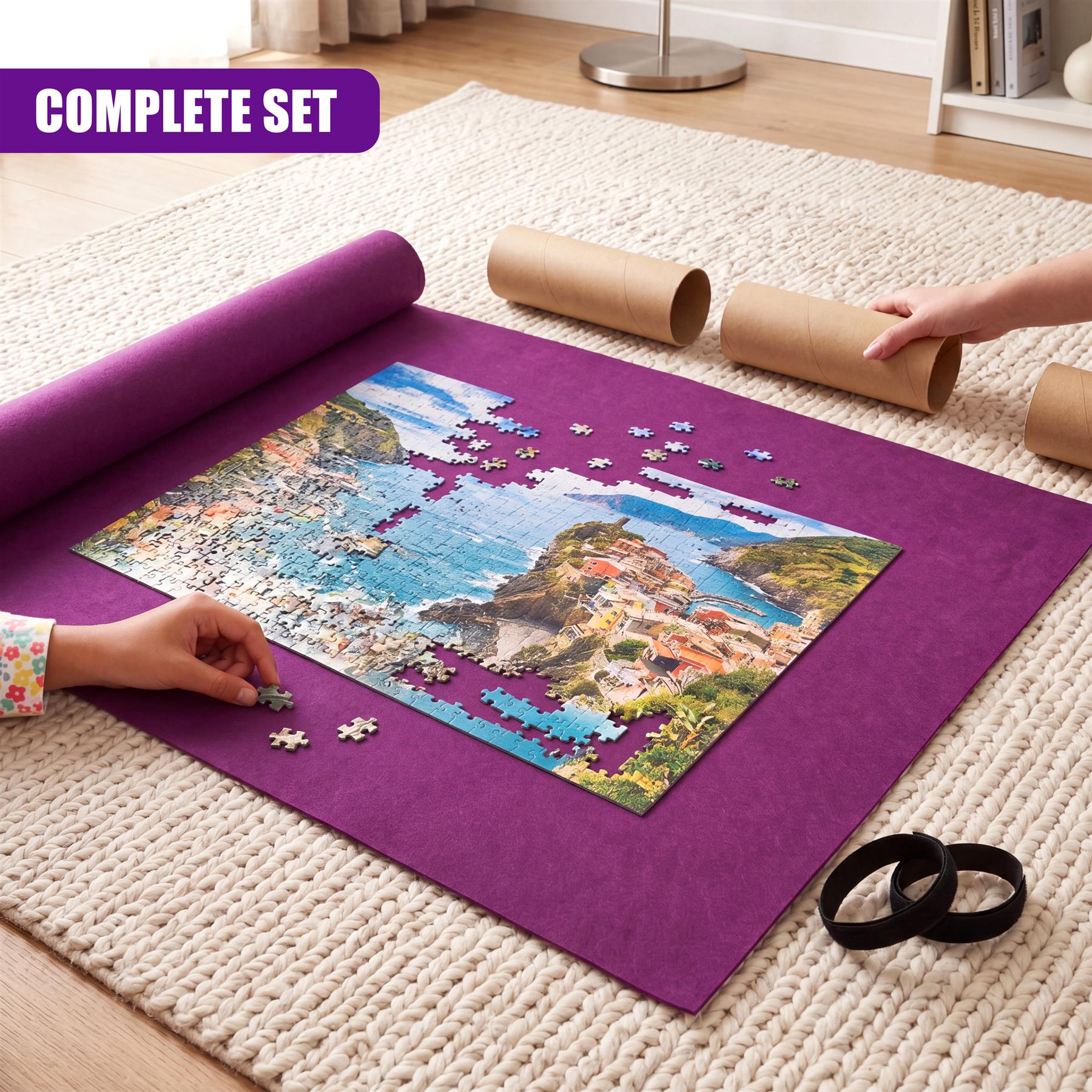 A purple mat displays a partially assembled coastal jigsaw puzzle and rolled-up sections.