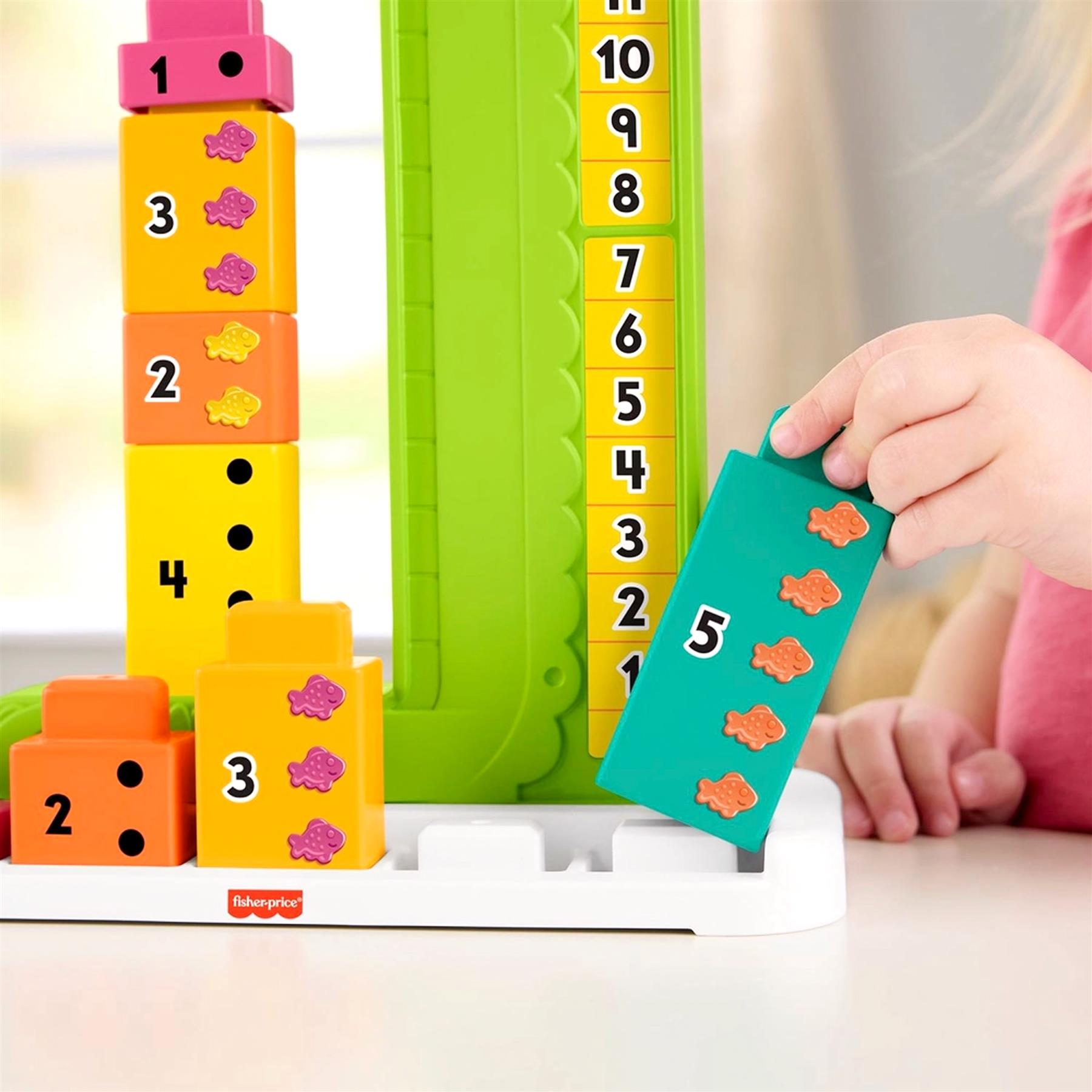 The toy includes number blocks, a vertical column, and a removable green alligator piece for counting.