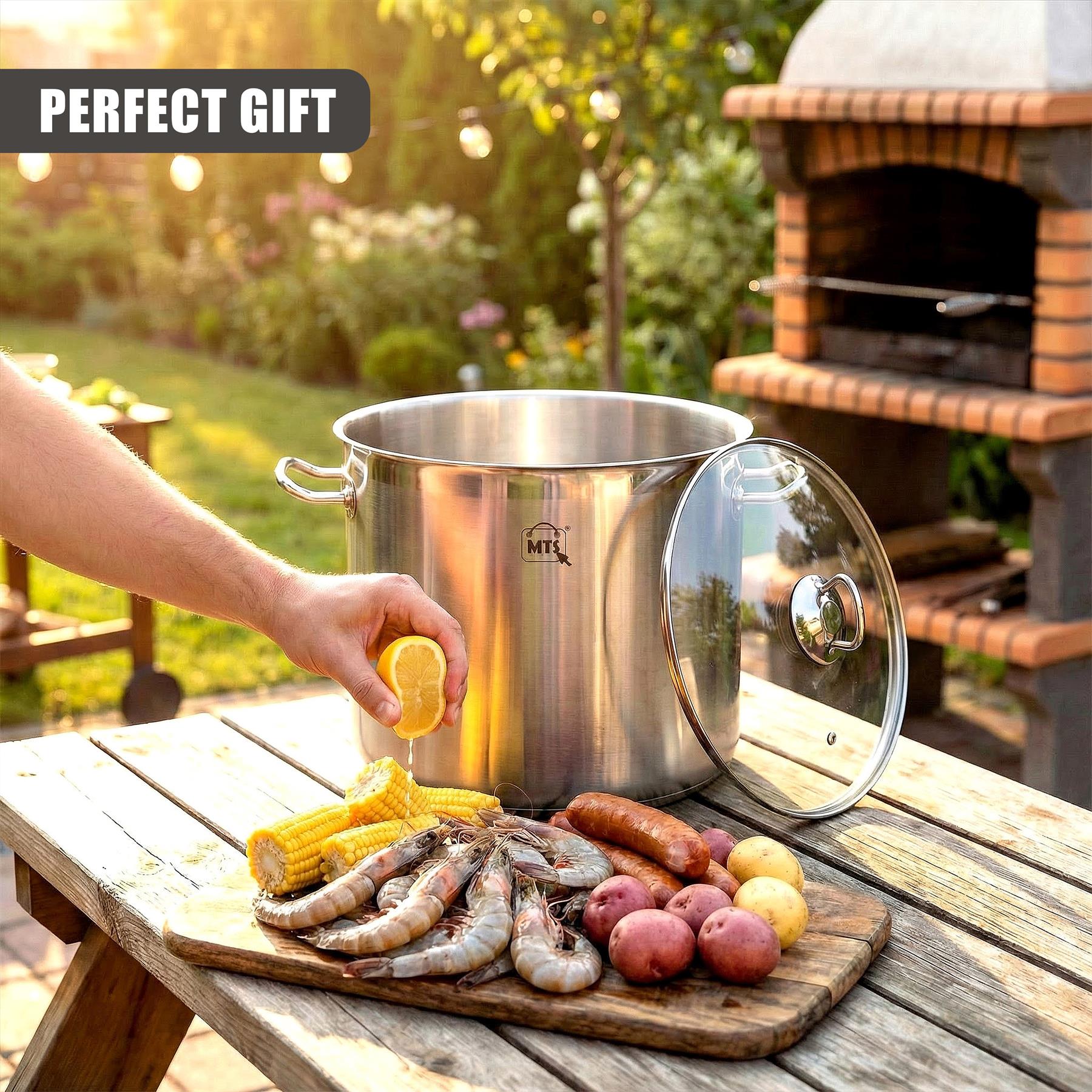 Stainless steel stockpot with glass lid sits near a wooden board holding corn, sausages, potatoes, and snails.