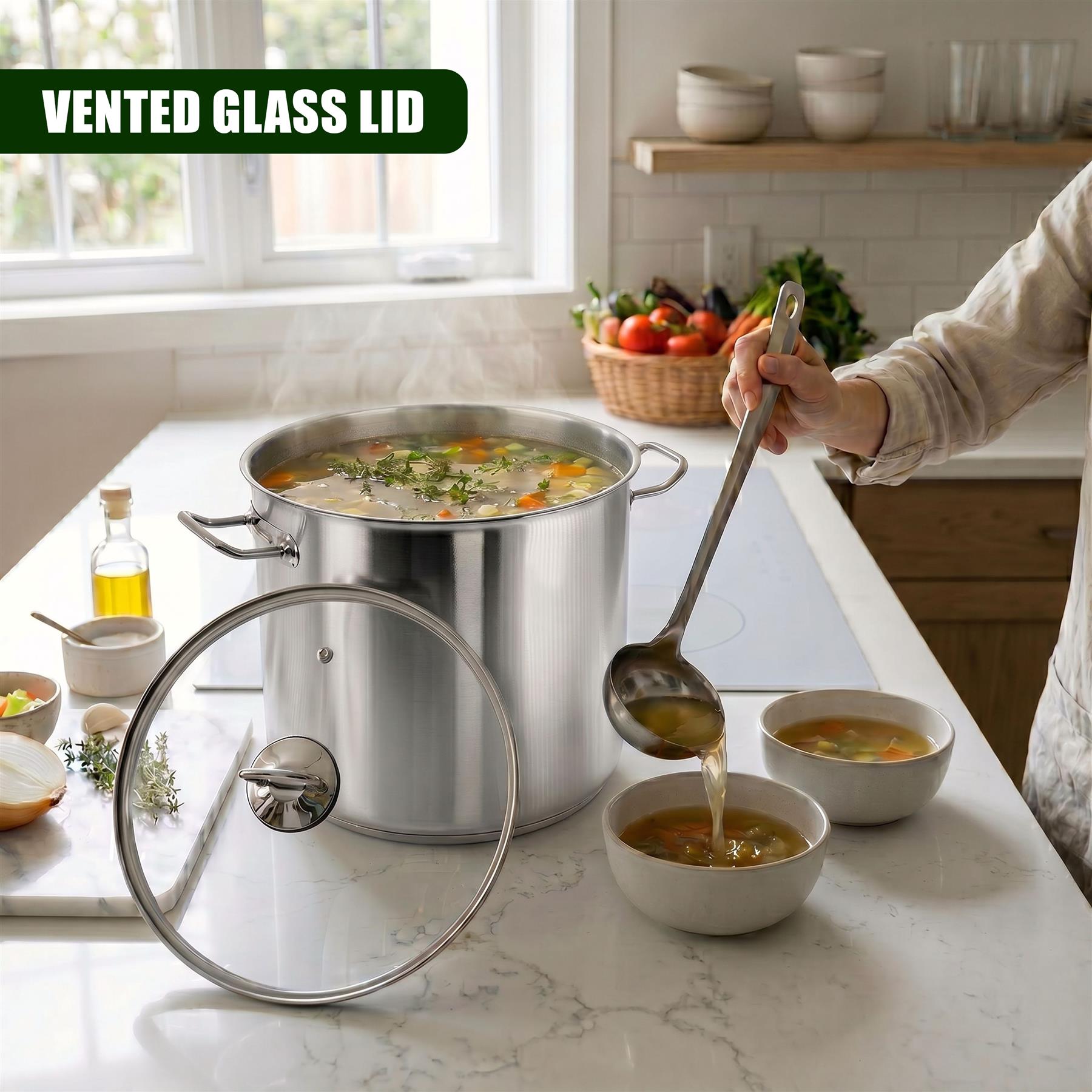 Large stainless steel stockpot, glass lid, and ladled soup on a kitchen countertop.