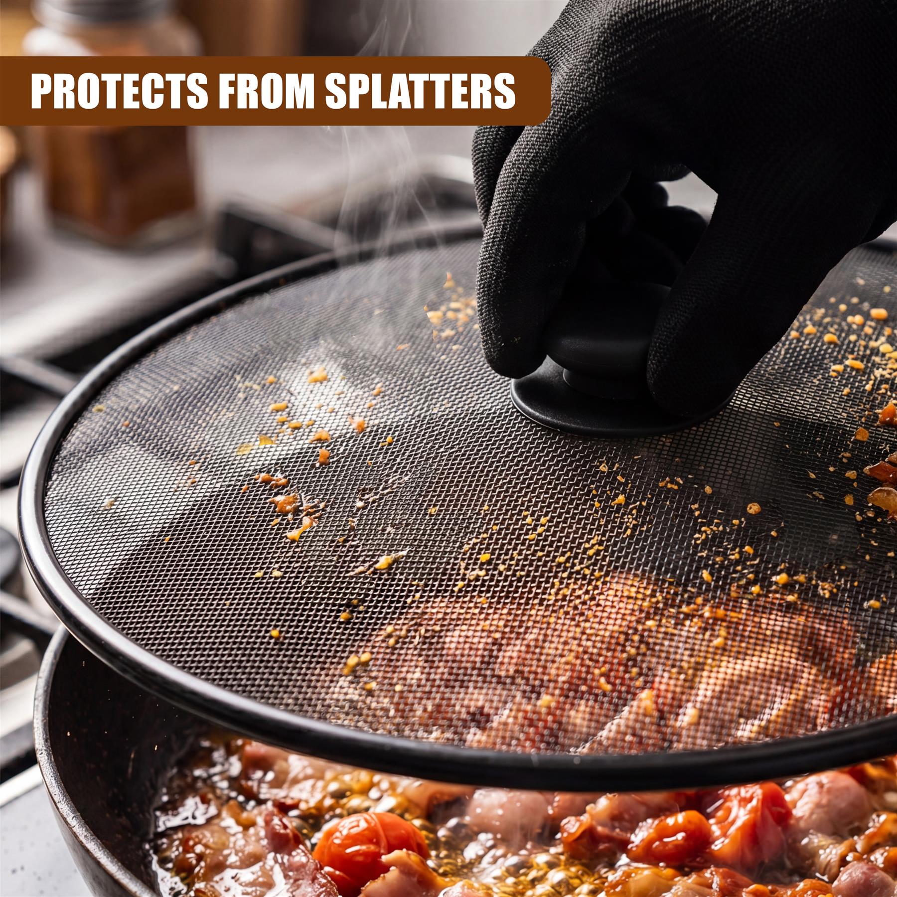 Black mesh splatter screen held over a pot of cooked tomatoes and simmering sauce.