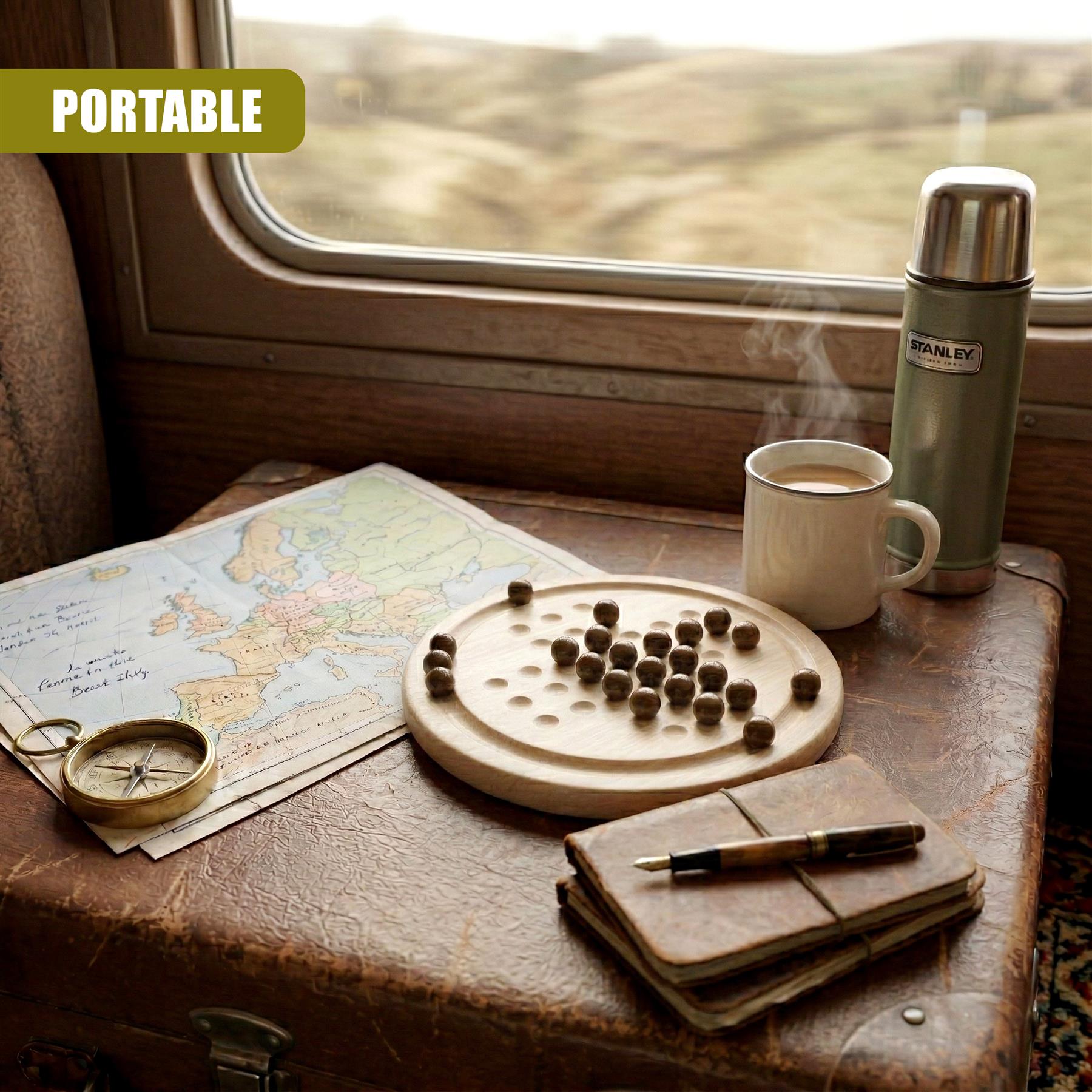 Solitaire board game with pieces displayed among coffee, maps, and notebook.