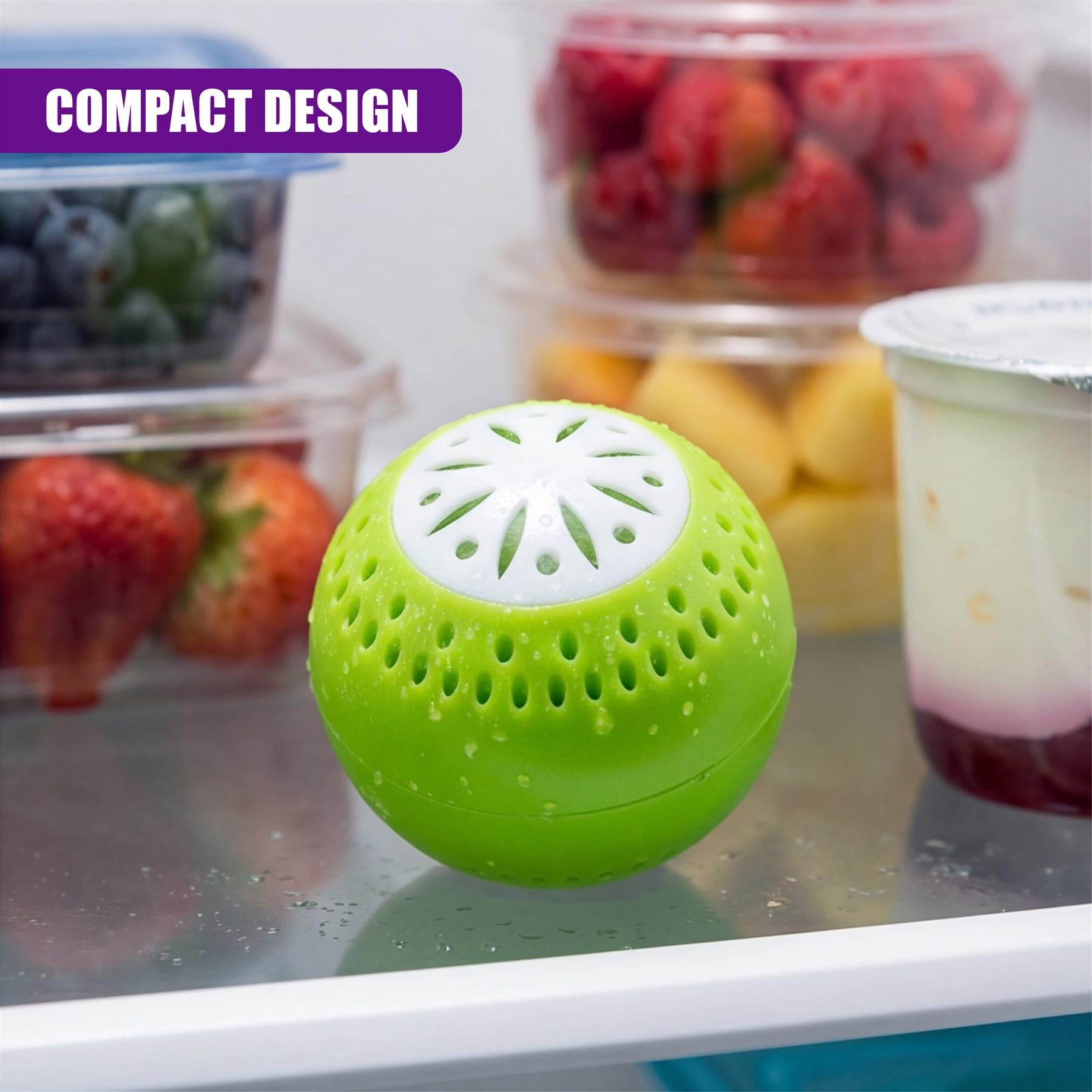 Green, porous sphere deodoriser rests on a surface near containers filled with berries and fruit.