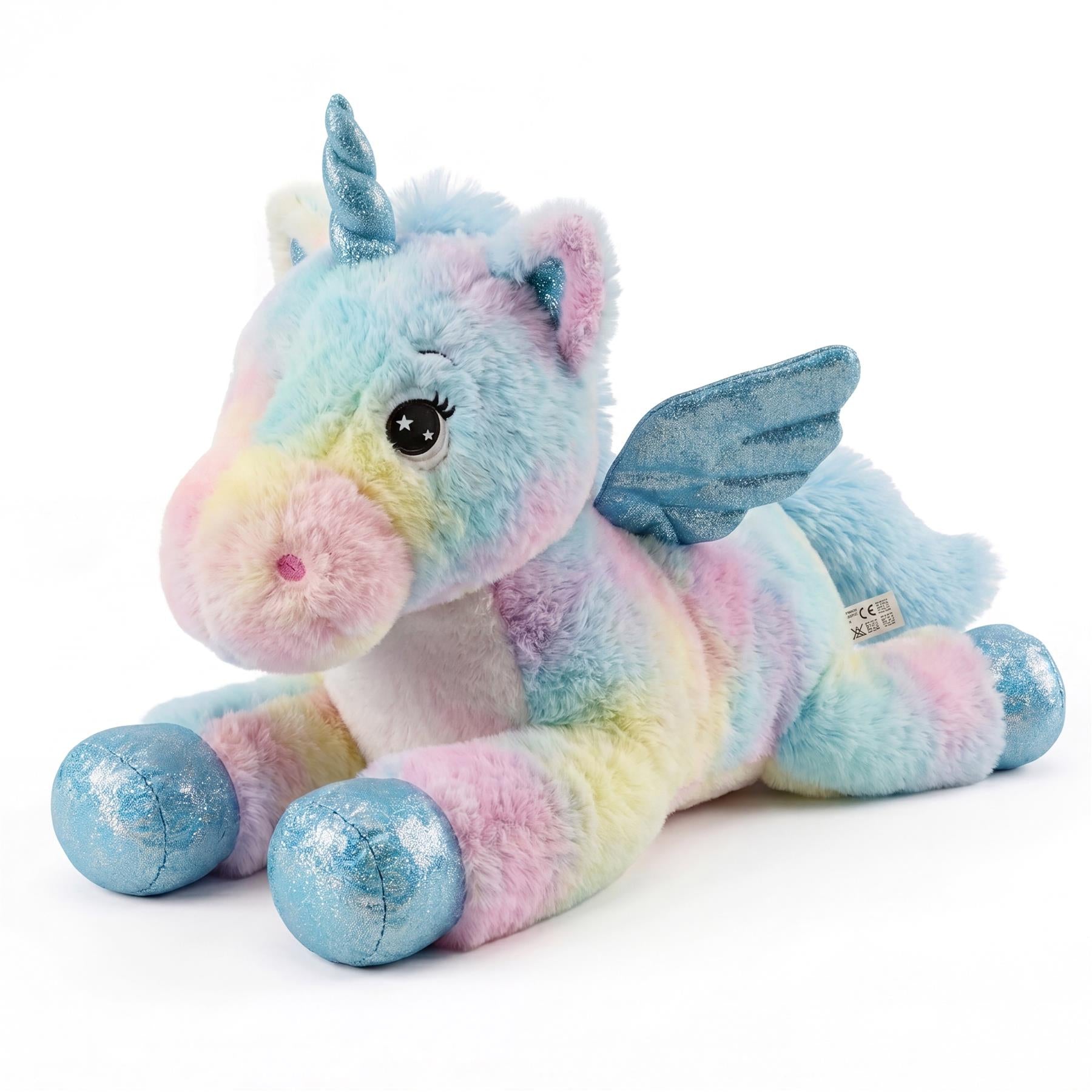 Pastel stuffed toy unicorn lying down, featuring rainbow coloring, a horn, and blue wings.