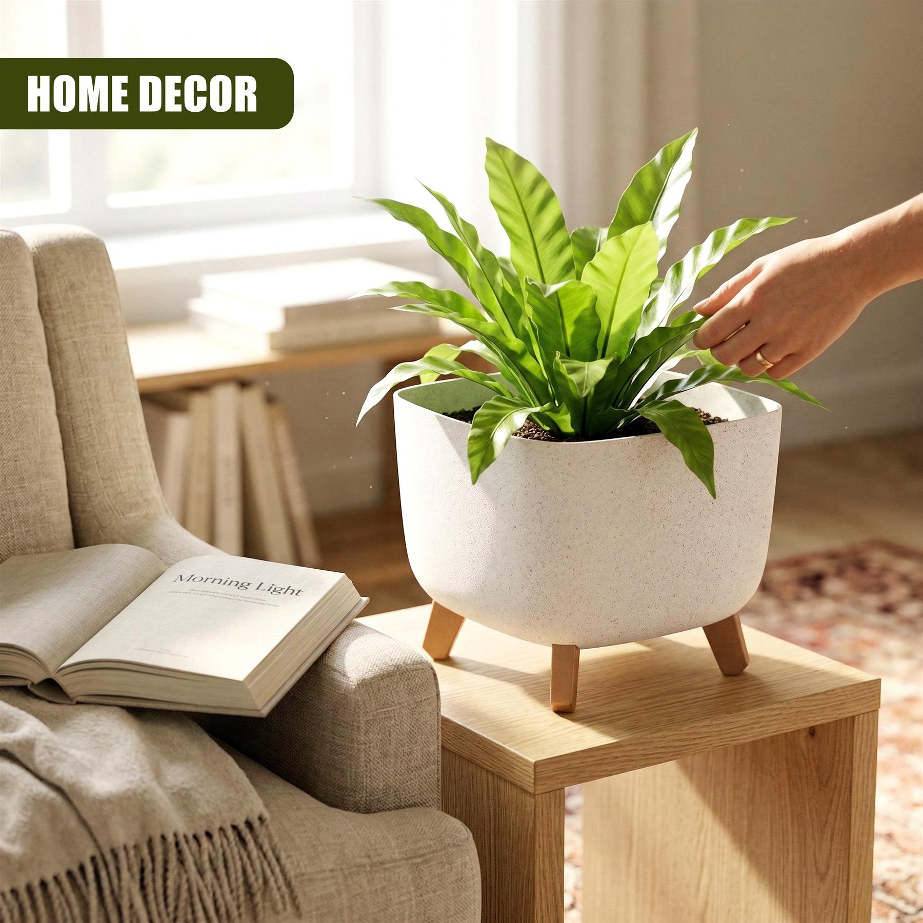 White ceramic planter with three legs holding a vibrant green potted plant on a wooden table.