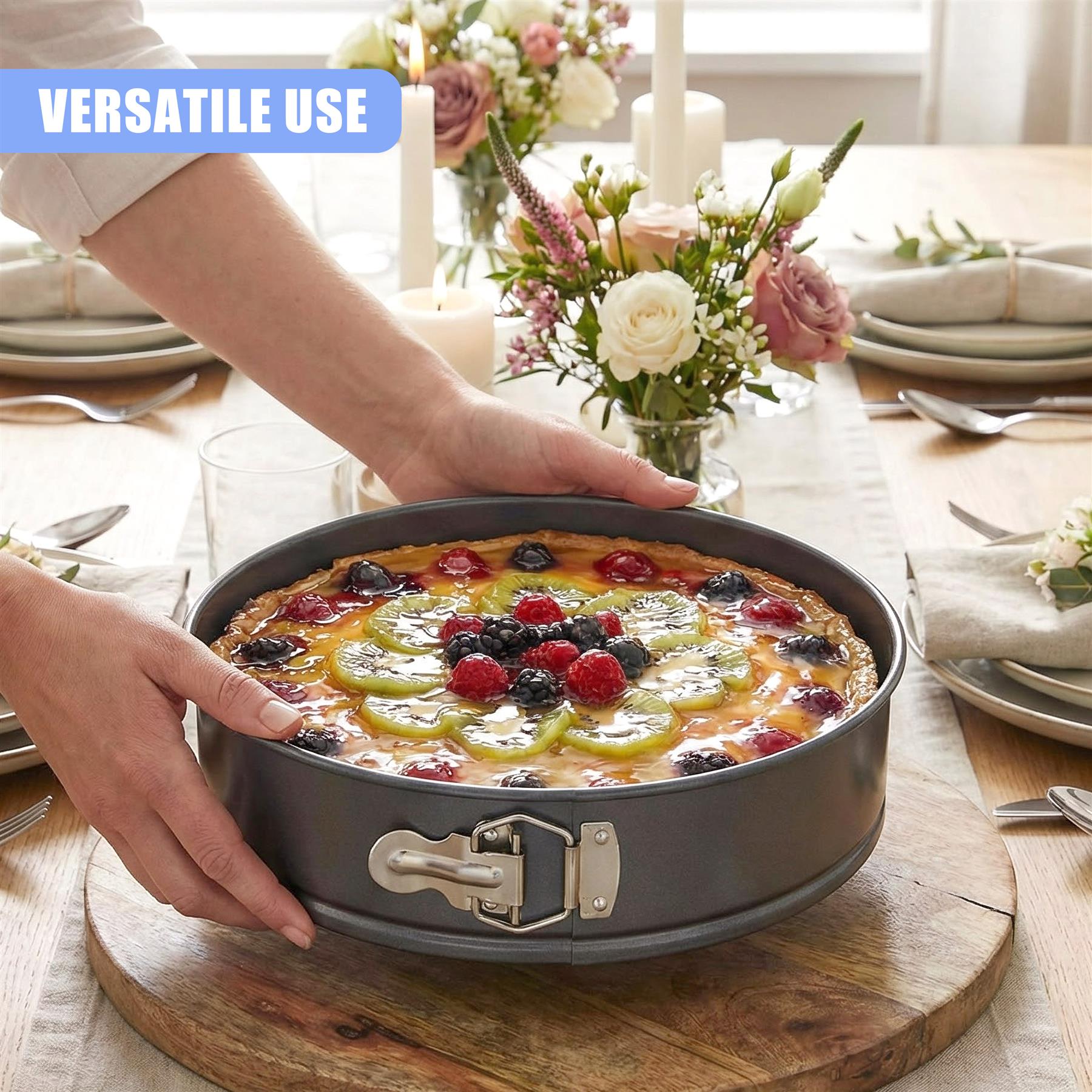 Hand placing a baked cake with blueberries and yellow fruit slices into a springform pan.