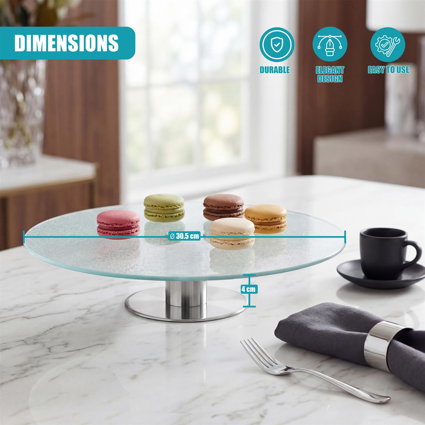 Clear glass cake stand on a metal pedestal displays macarons on a white marble surface.