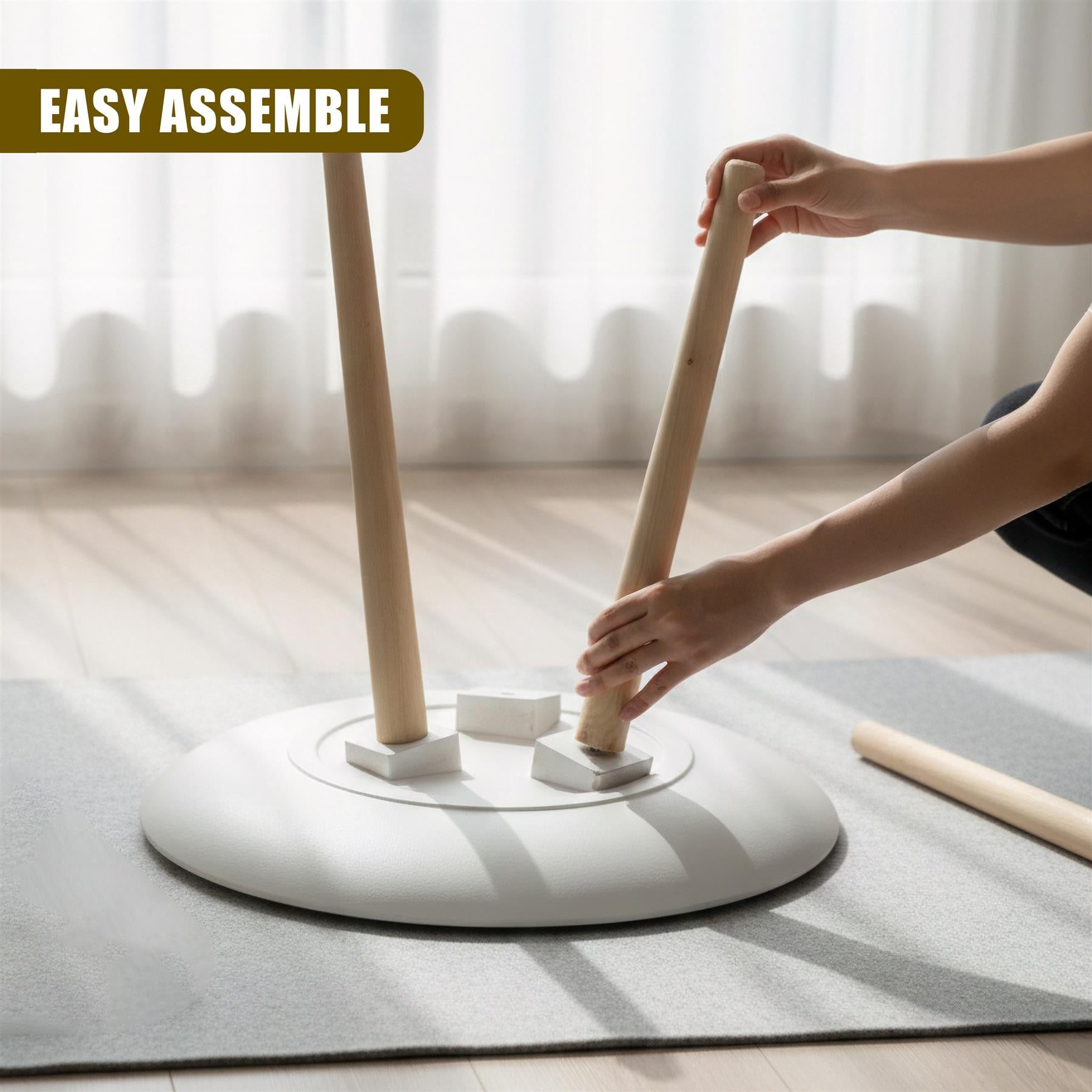 Hands assemble two wooden support posts onto the round white side table base.