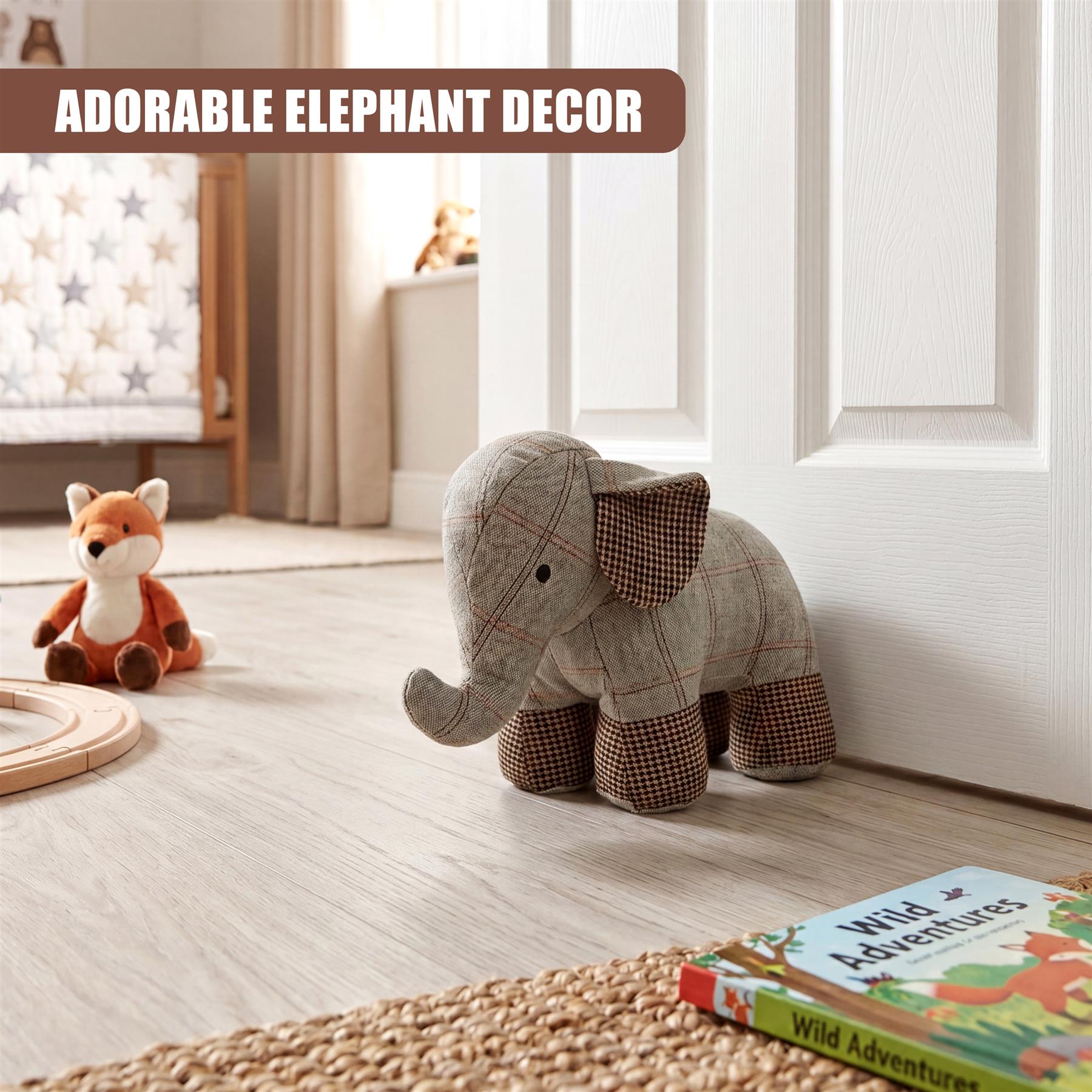 Tartan grey elephant novelty door stopper resting on a light hardwood floor.
