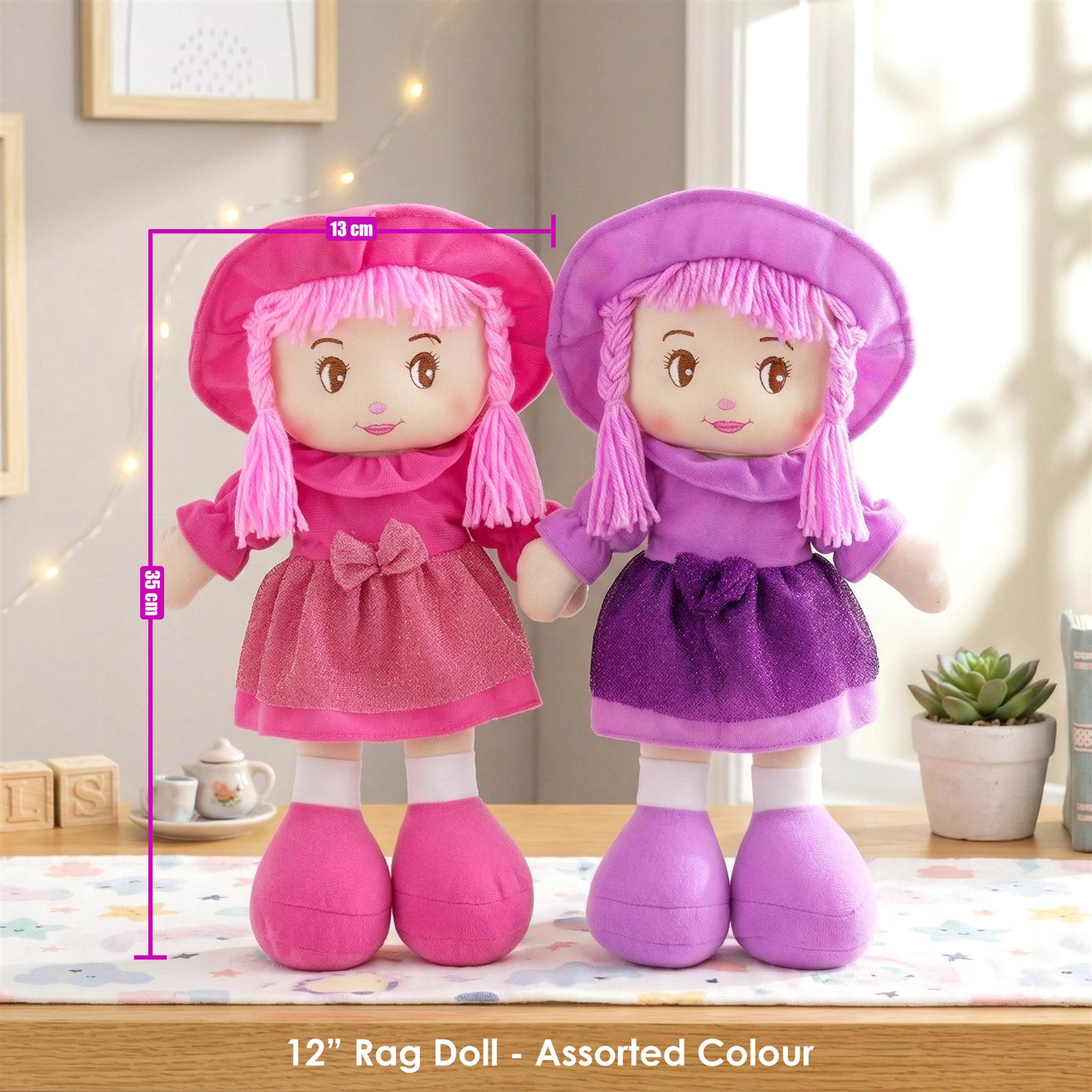 Pair of rag dolls dressed in pink and purple outfits and matching hoods.