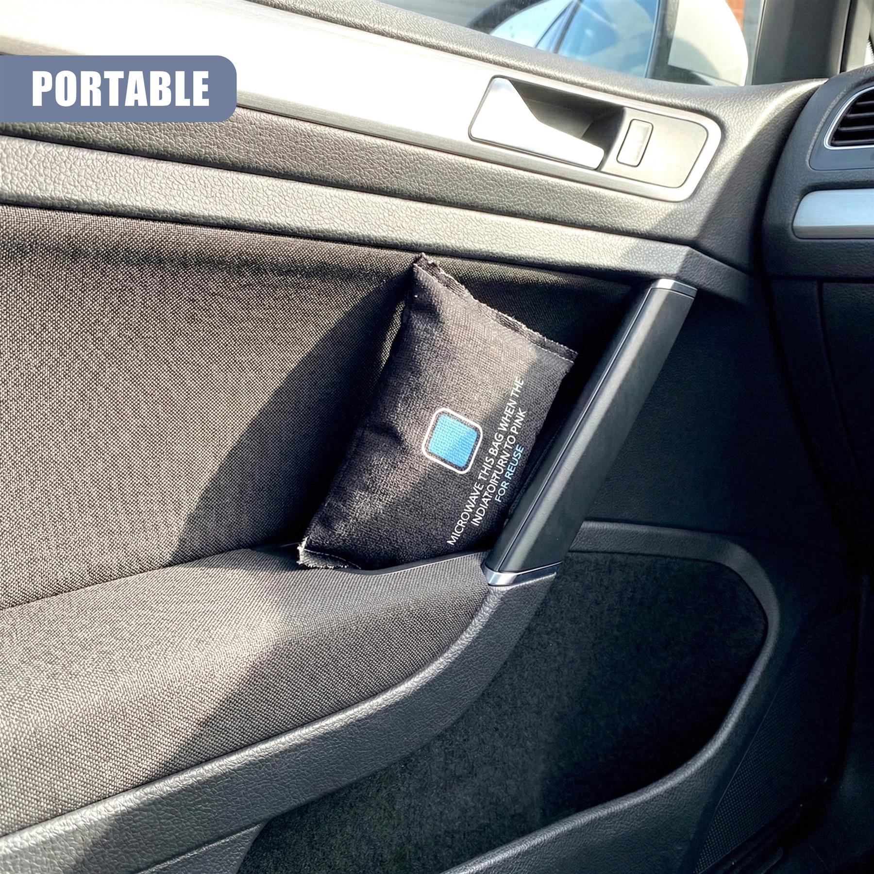 A dark fabric dehumidifier bag is situated within the car's interior cupholder pocket.