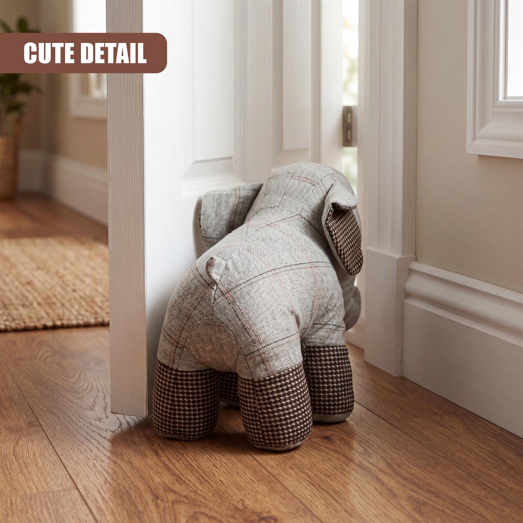 Tartan elephant door stopper resting against a white door frame.