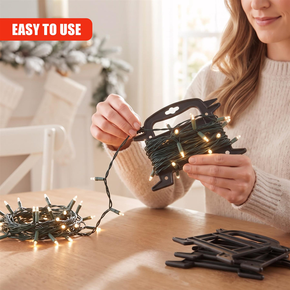 A woman uses a GEEZY Christmas light reel storage holder to neatly coil fairy lights