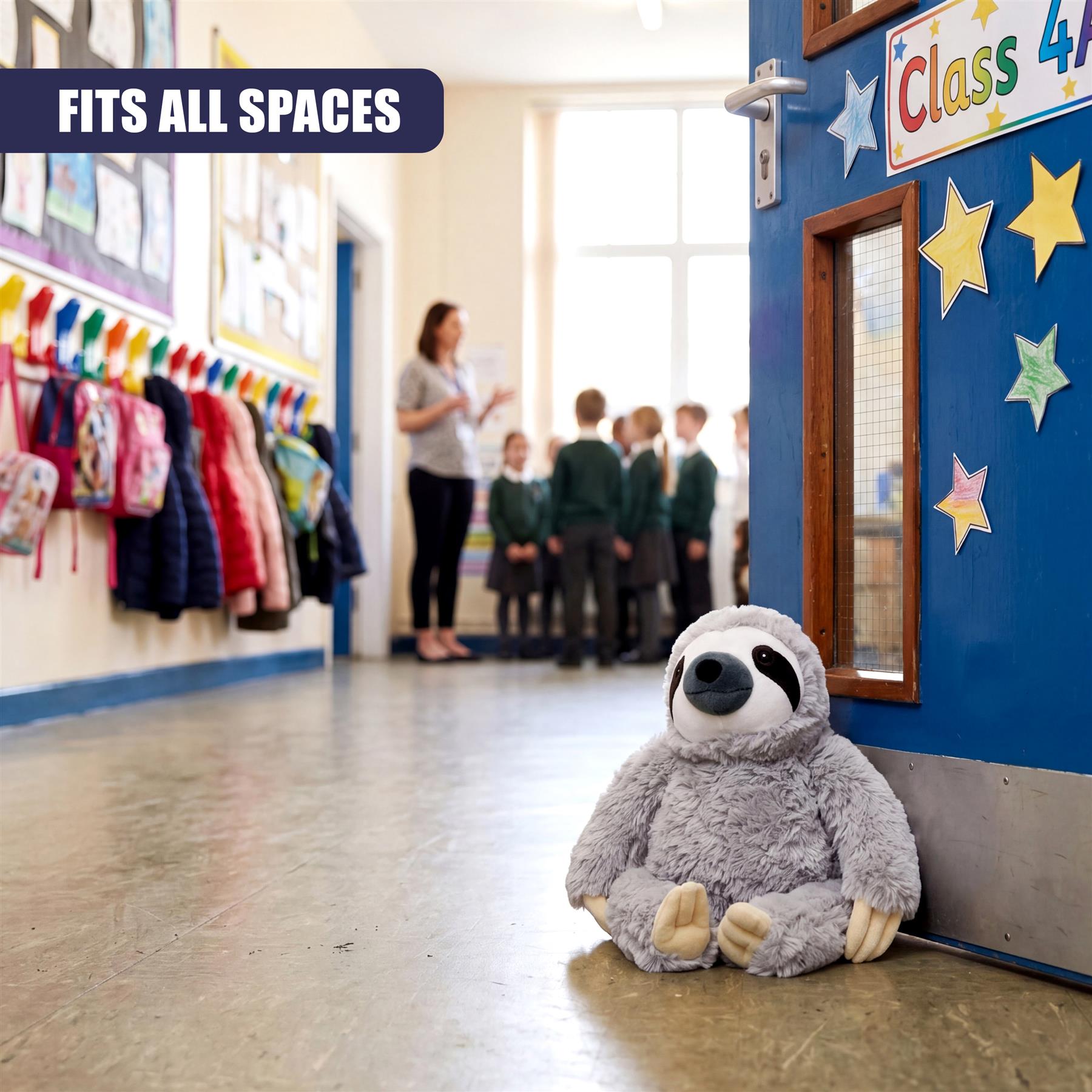 Grey plush sloth stopper rests against a bright blue wall surface in a classroom hallway.