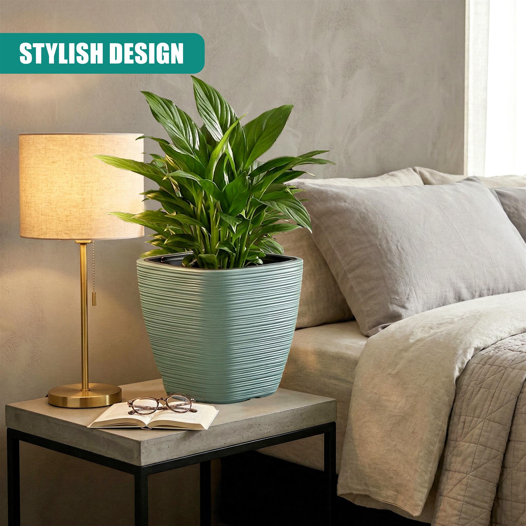 A light blue, ridged square planter holds a vibrant green houseplant on a gray side table.