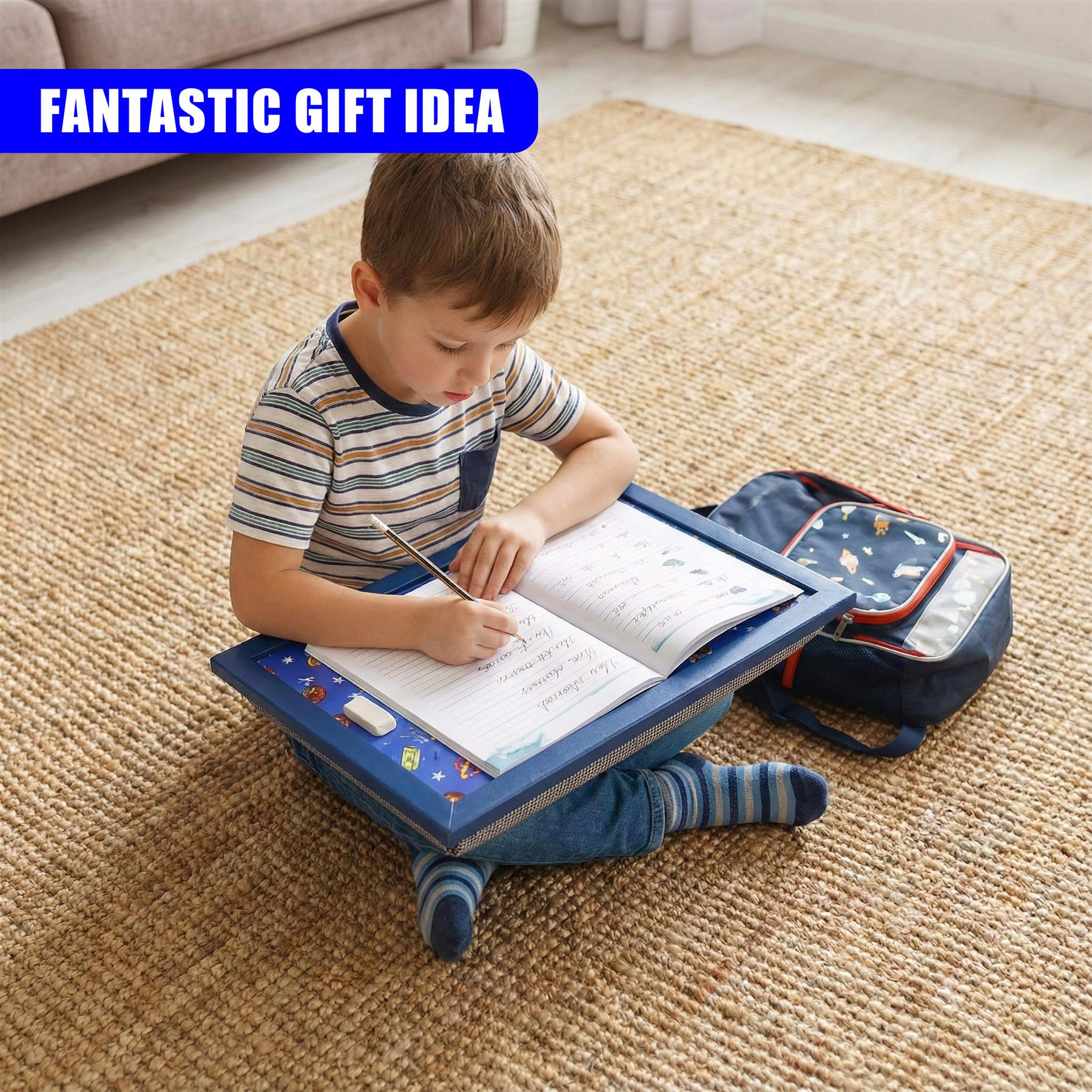 Portable lap tray supporting book work, displayed with an attached storage bag for supplies.