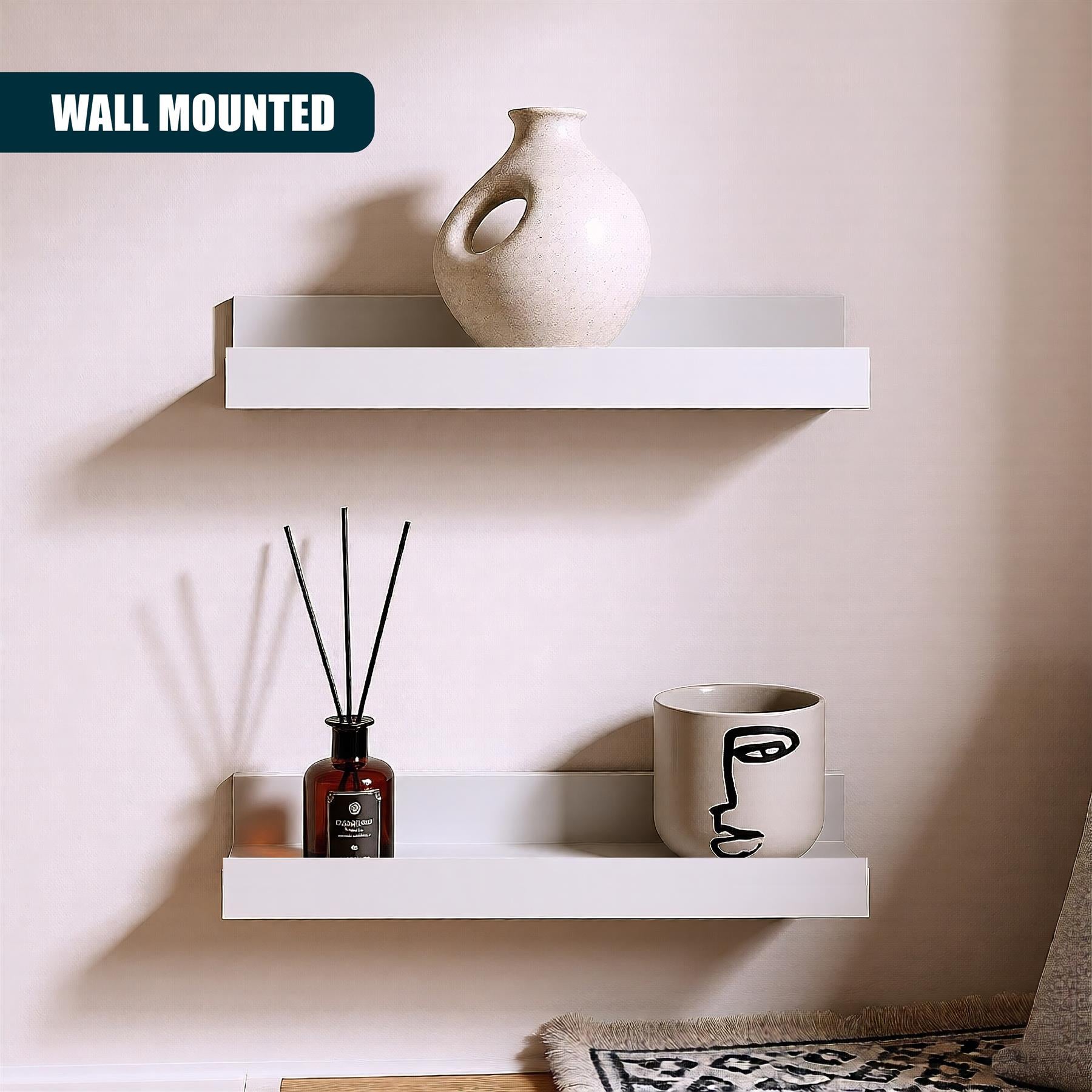 A wall-mounted shelf with two shelves, one above the other. The shelves are white and have a simple, minimalist design. They are mounted to the wall using a bracket or a wall-mounted shelf system. The shelves are empty, but they can be used to display small objects, such as books, photos, or decorative items. The wall behind the shelves is white and has a few minor imperfections, such as a small patch of paint or a slight imper - The Magic Toy Shop