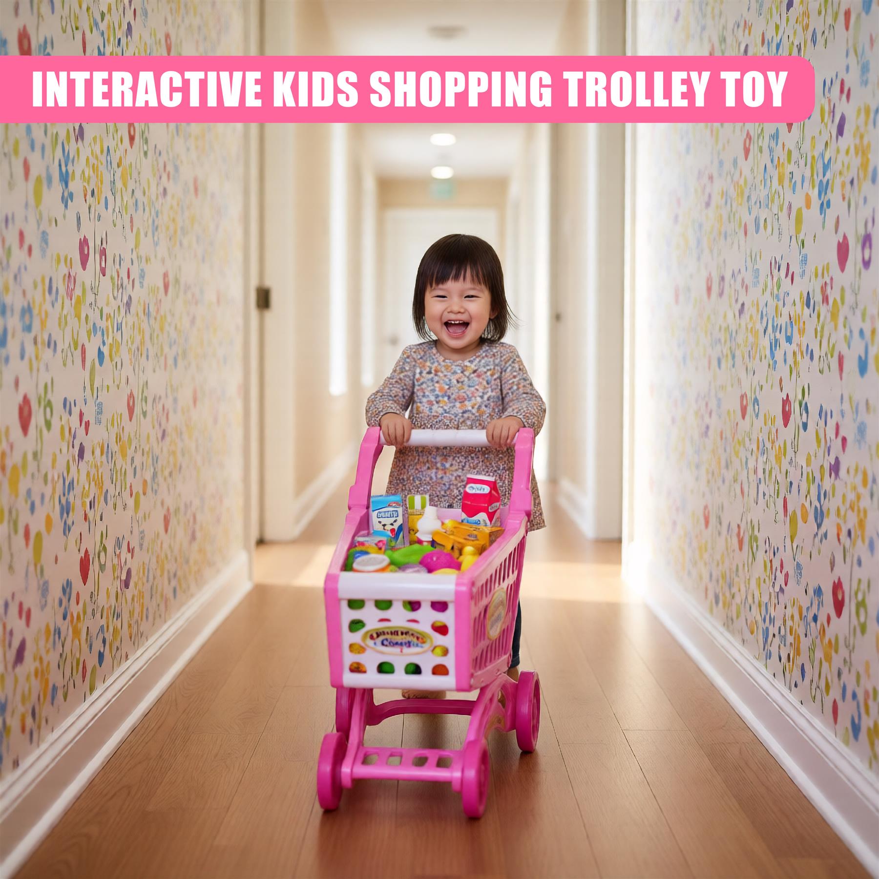 A young child in a pink shirt pushing a shopping trolley filled with toys, standing on a patterned floor with walls adorned with colorful wallpaper, suggesting an interactive shopping trolley toy set for kids. - The Magic Toy Shop