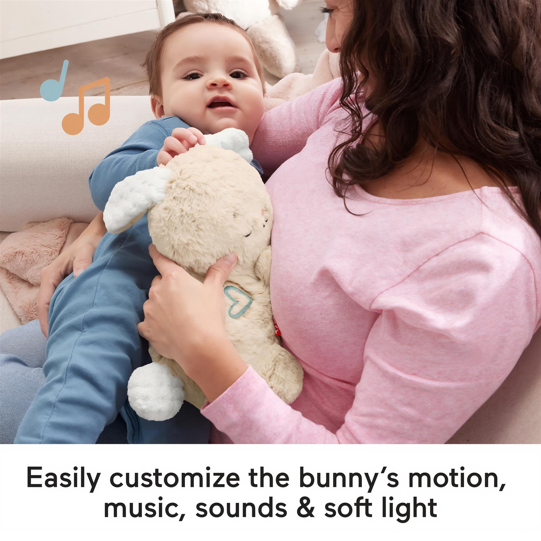 A mother holding a baby and a plush bunny toy.