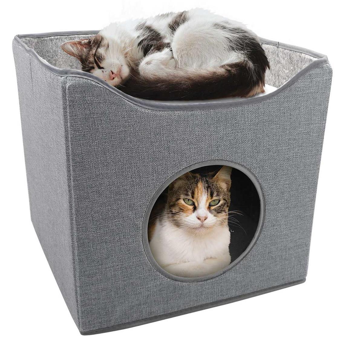 A grey fabric cat bed with a built-in hideout, featuring a sleeping cat inside and another cat peering out of the hideout. The bed has a soft, cushioned interior and a sturdy, foldable design. - The Magic Toy Shop