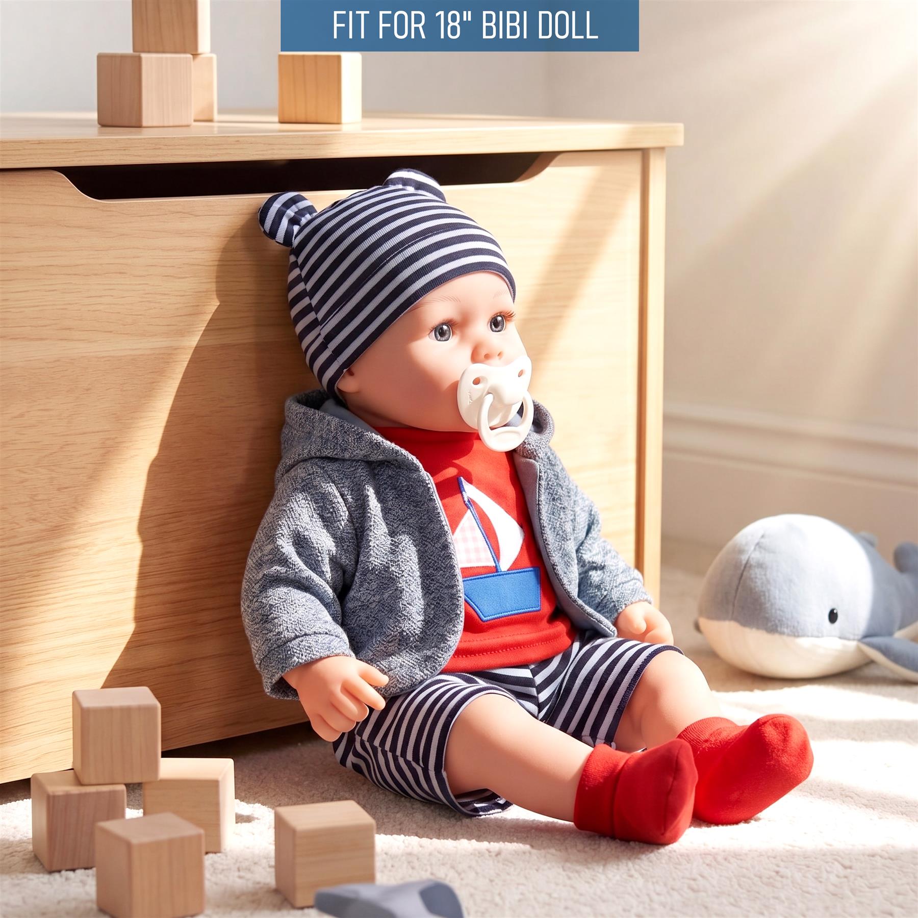 The doll is wearing a gray jacket, striped blue hat, and striped red pants.