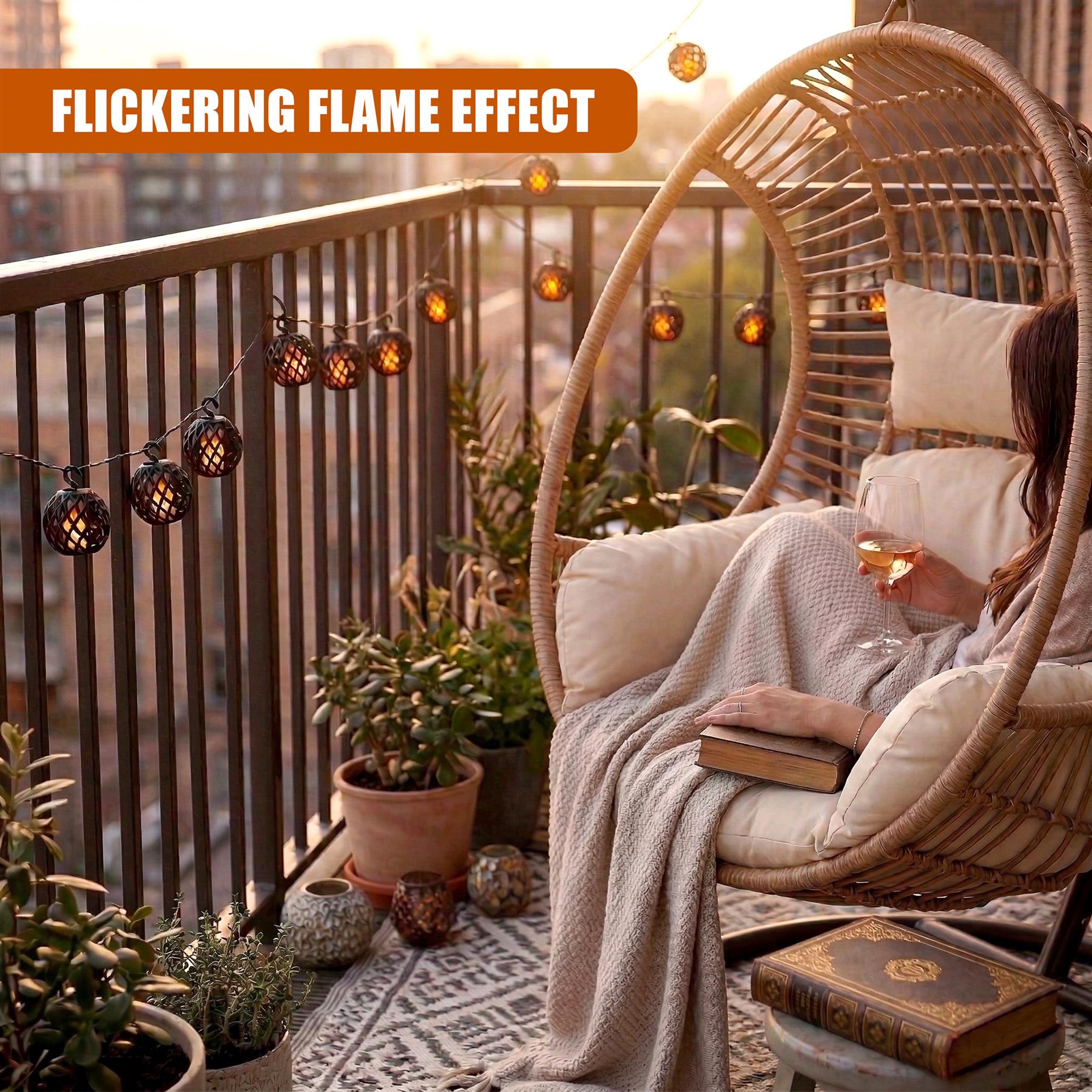Solar string lights with hanging orbs illuminate a tropical balcony railing and swing chair.