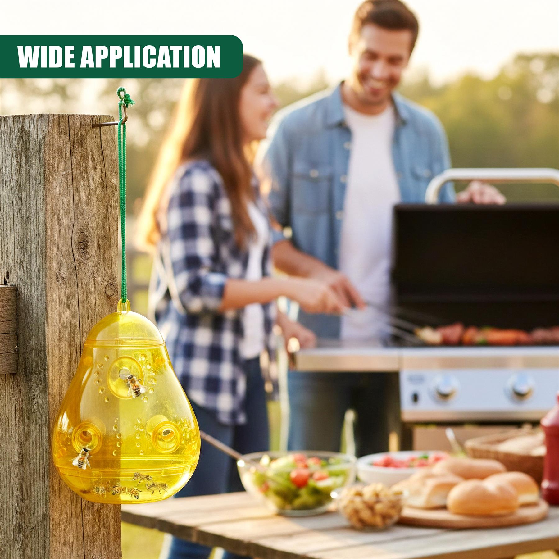 Yellow wasp trap hangs from a wooden post near a summer barbecue setting.