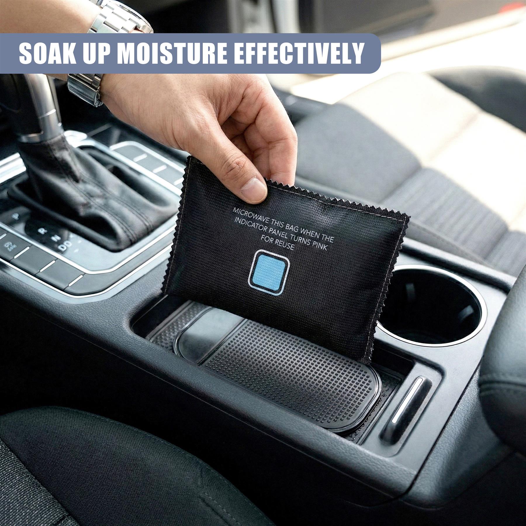 A hand places a rectangular, black reusable dehumidifier bag into a car's center console cup holder.