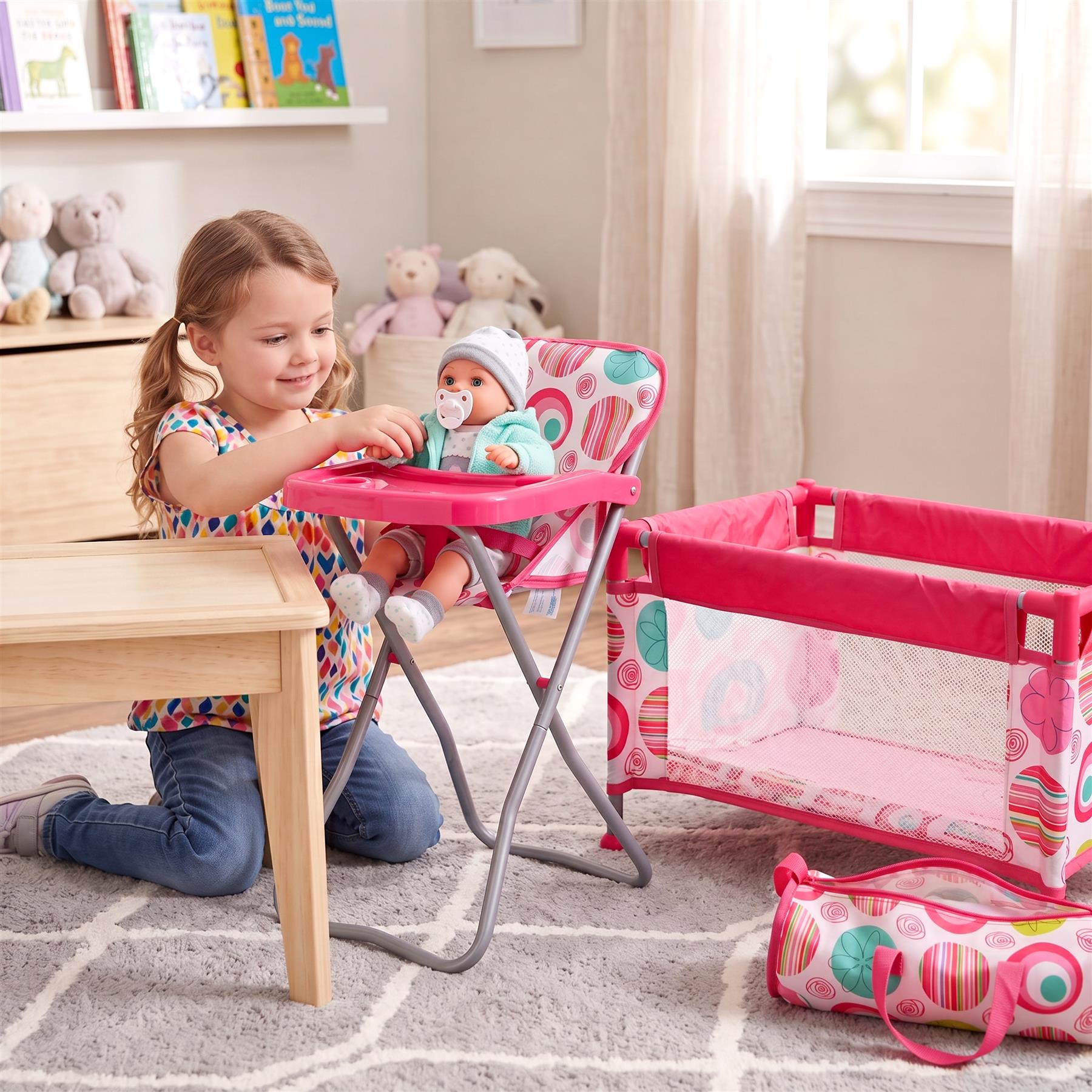Girl sitting at a table with baby in a pink high chair, cot, and patterned bag visible.