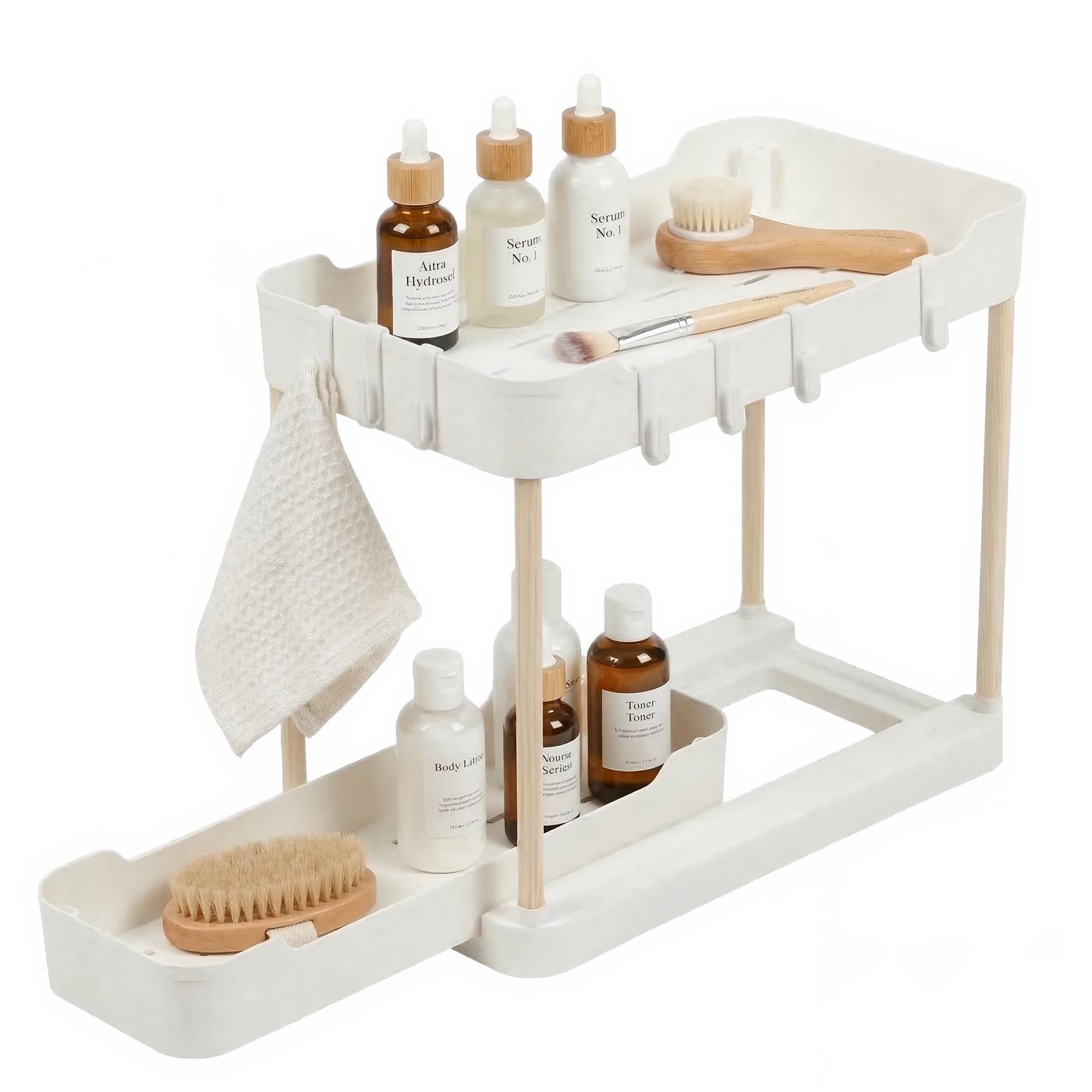 White two-tier pull-out cosmetic organizer holding serum bottles, brushes, and folded white cloth.