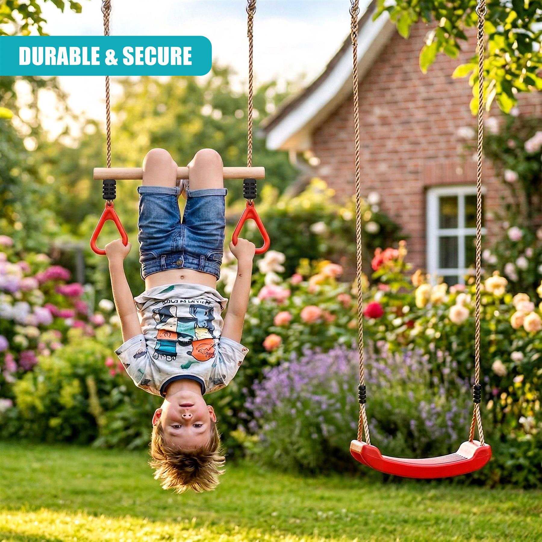 A boy hangs from a red trapeze swing set in a lush, blooming garden with greenery.