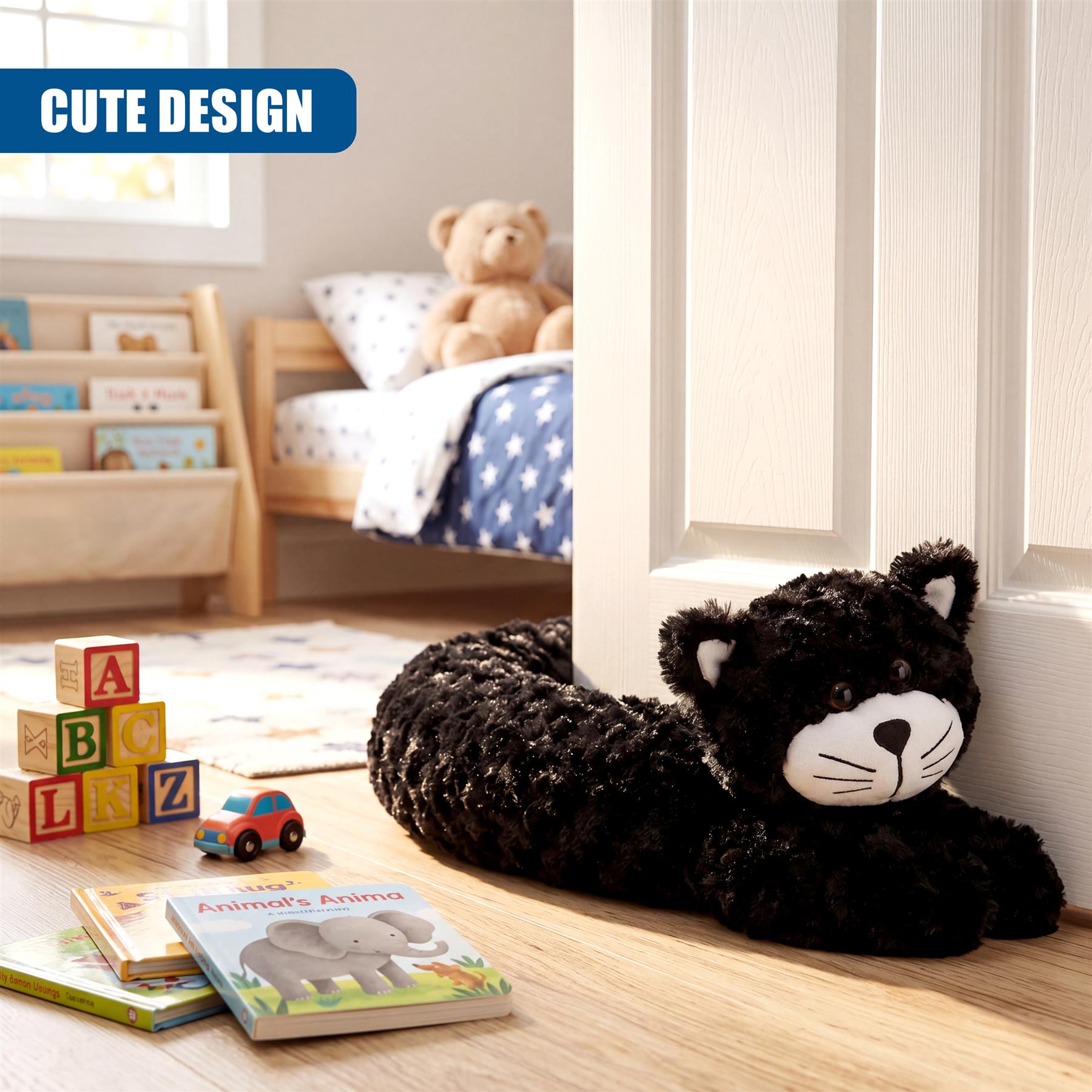 Black plush cat draught excluder is positioned on a light wooden floor near a white door.