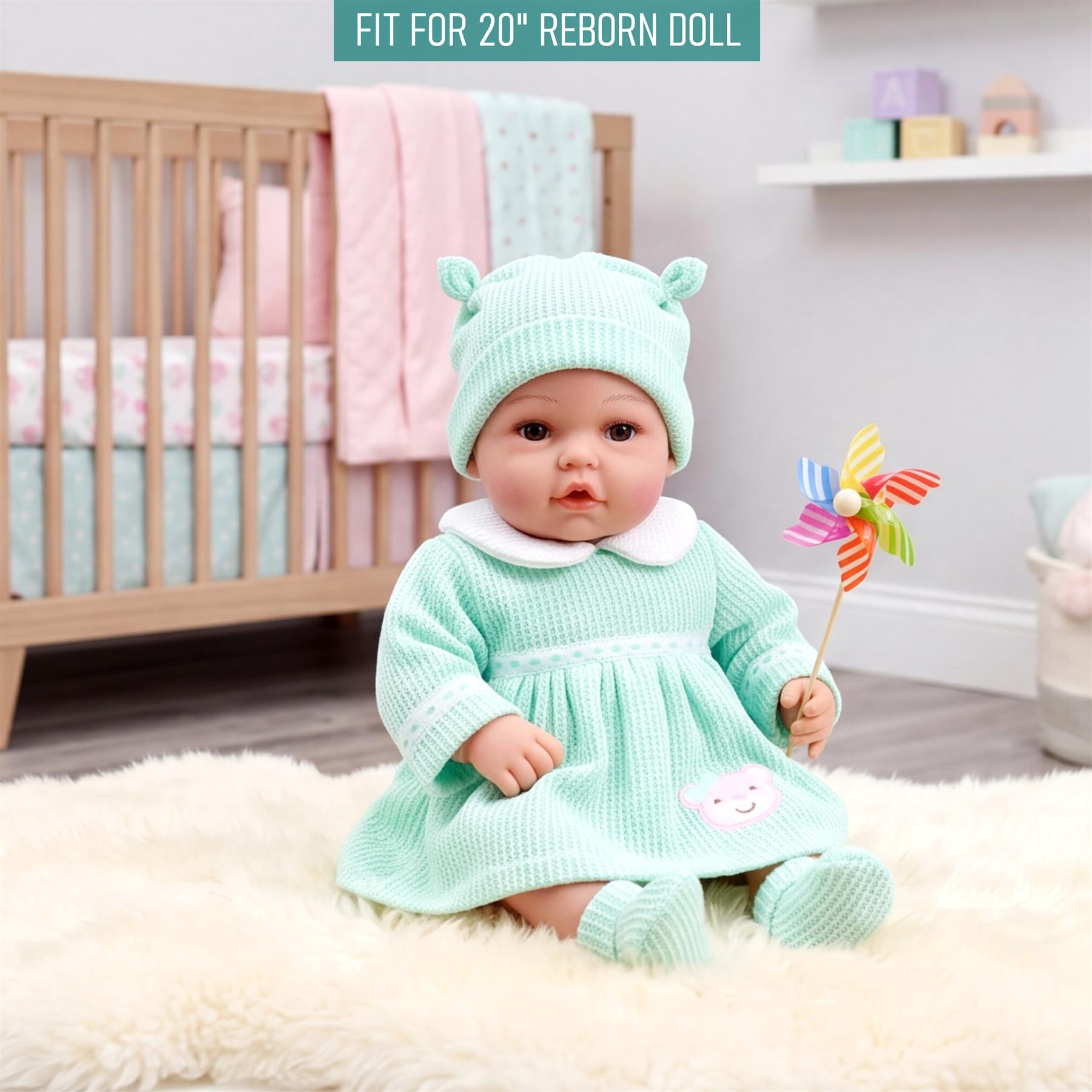 Mint green knit outfit for reborn dolls, featuring a matching hat and flared dress.