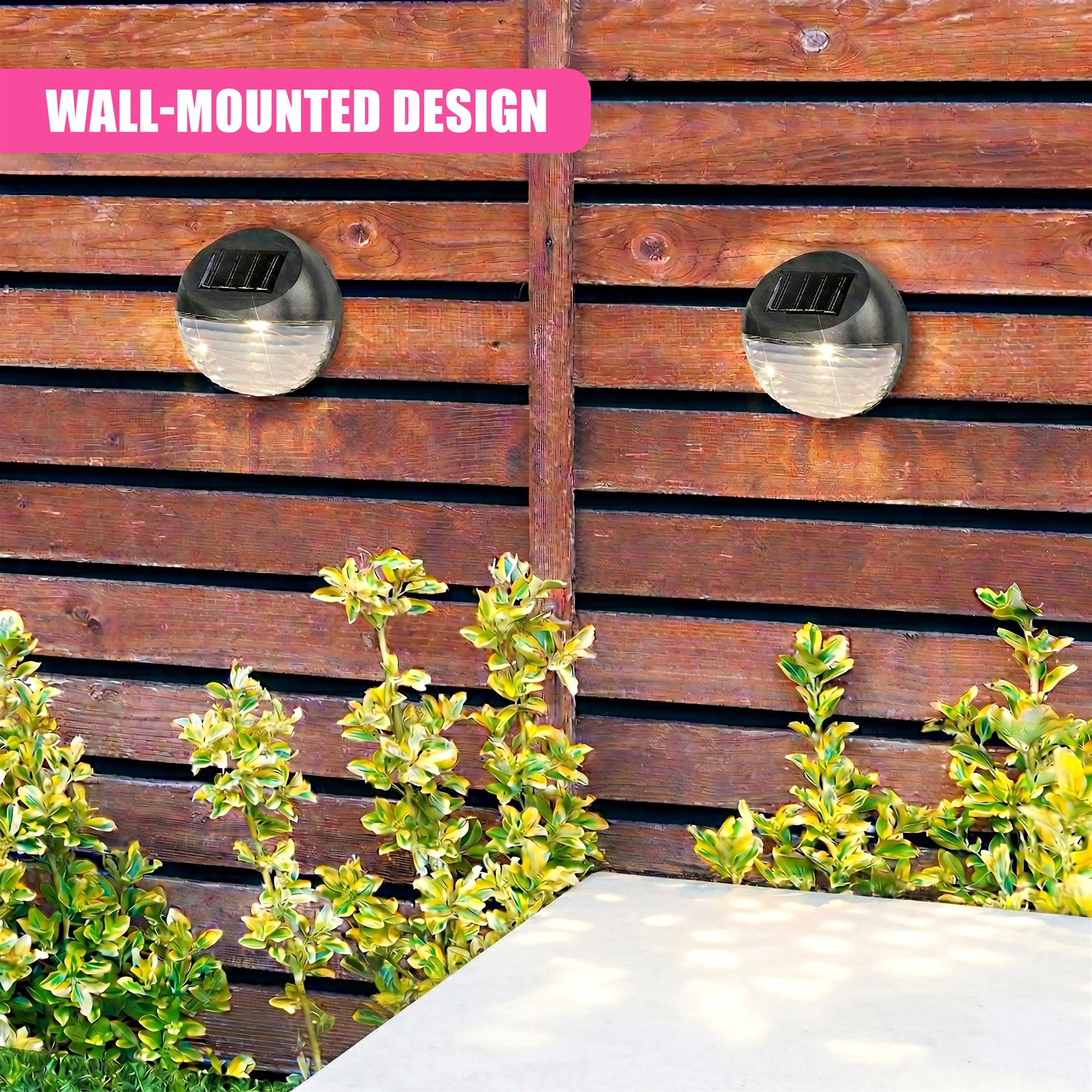 Two circular black outdoor solar lights are mounted on a horizontally slatted wooden fence.