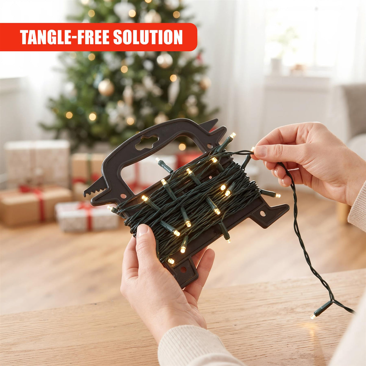 A person holds a GEEZY Christmas light reel storage with dark fairy lights