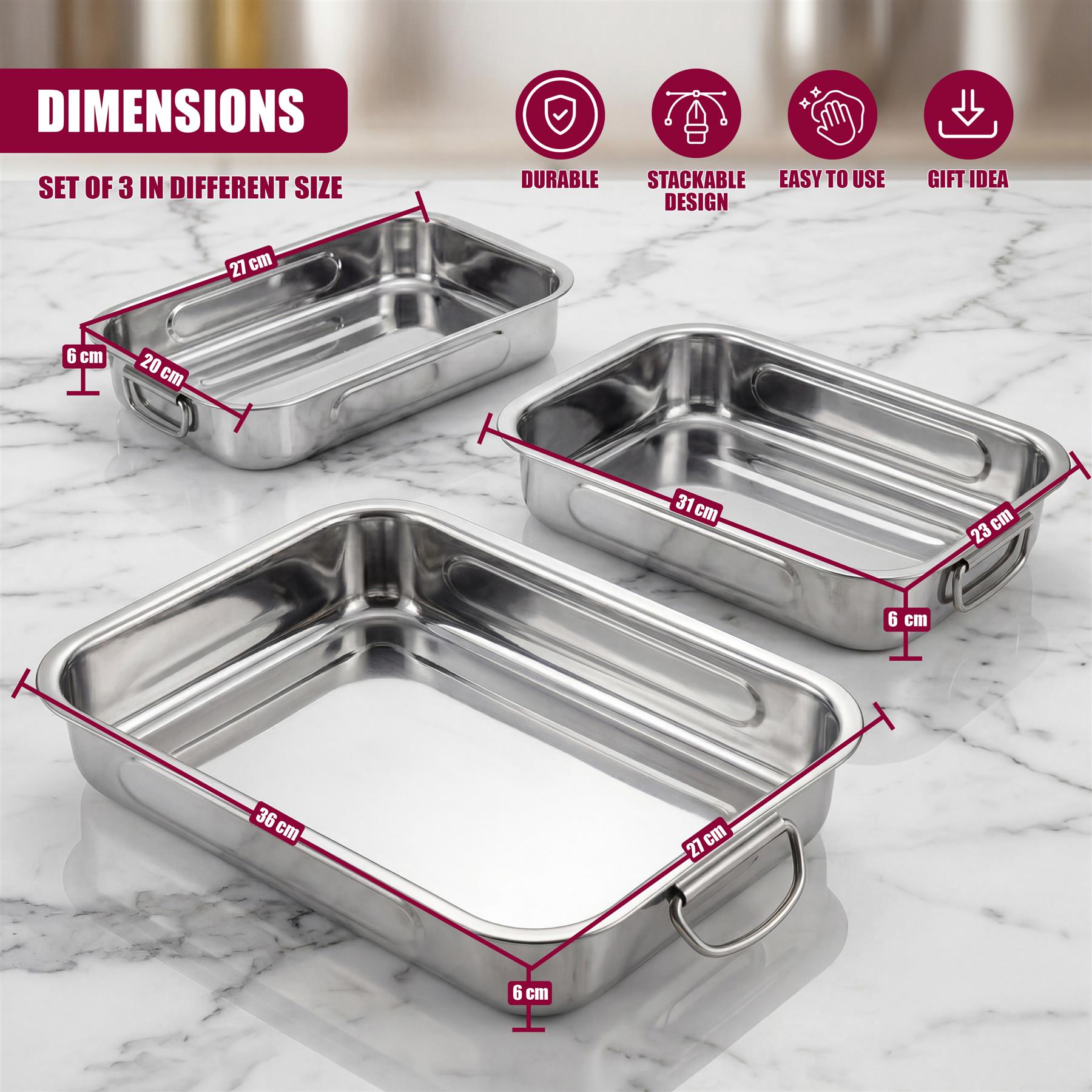 Three stainless steel roasting trays of different rectangular sizes are arranged on a white countertop.