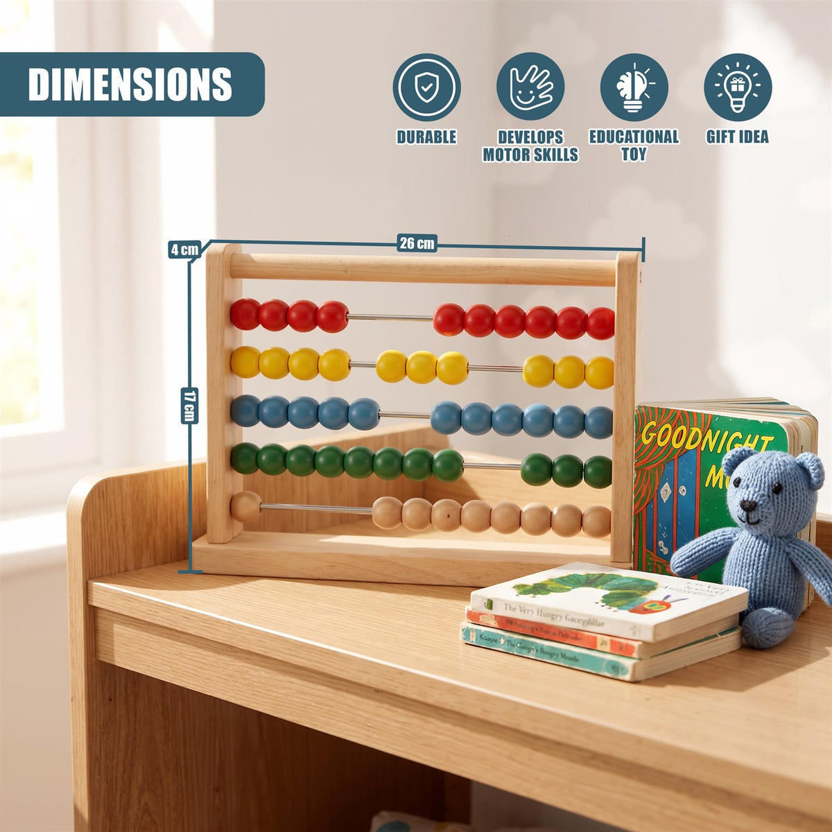 Wooden abacus with fifty beads in five colours sits on a wooden table with books and a teddy bear