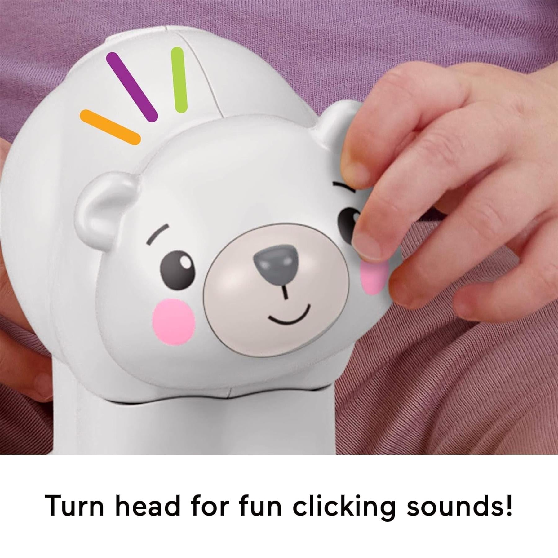 White polar bear toy with colorful lights and a hand visible touching its snout.