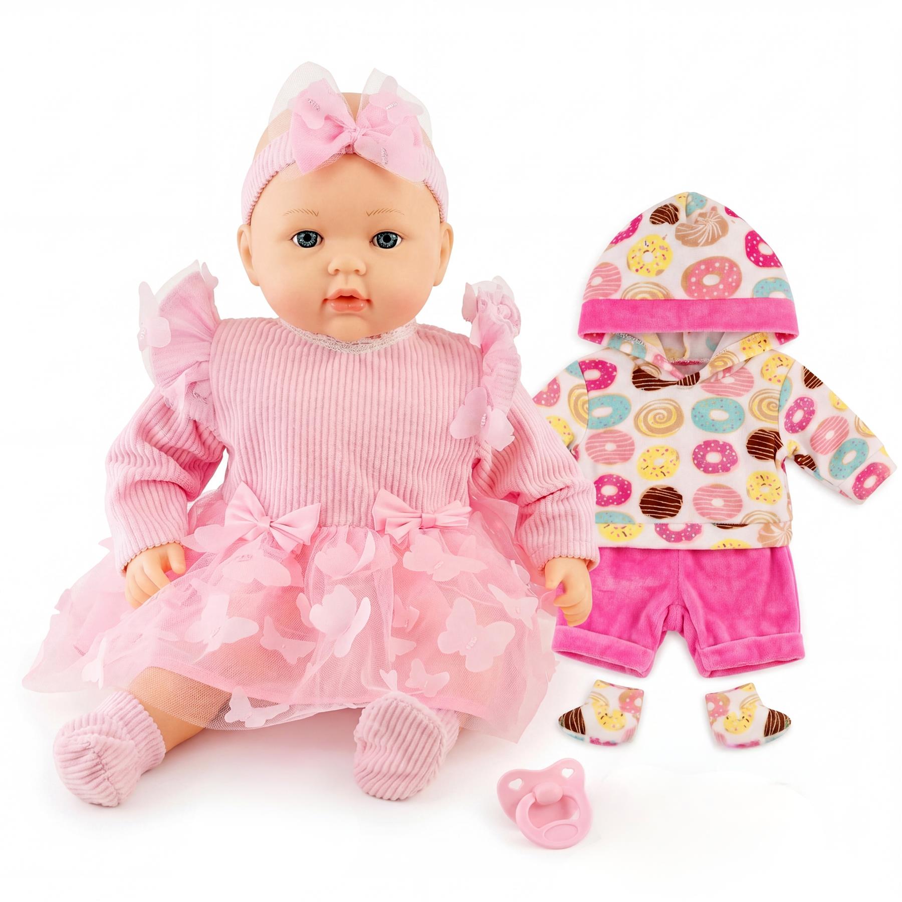 Baby doll in a pink ruffled outfit, displayed with patterned clothing, booties, and a pink pacifier.