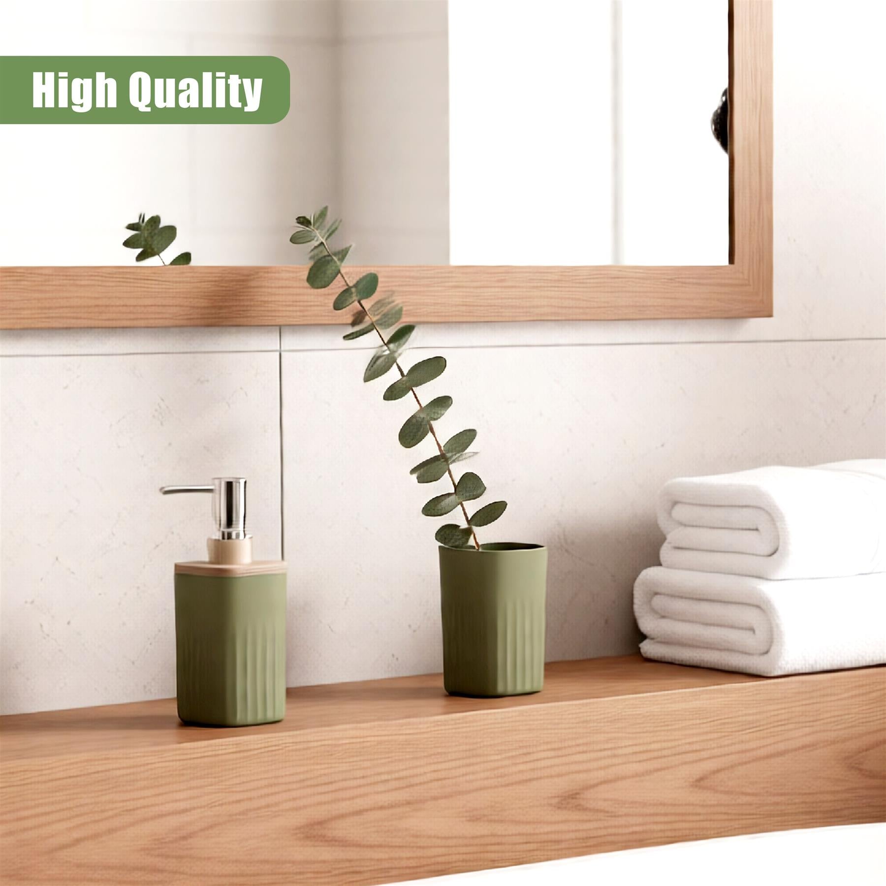 Sage green soap dispenser, potted plant, and stack of neatly folded white towels on a shelf.