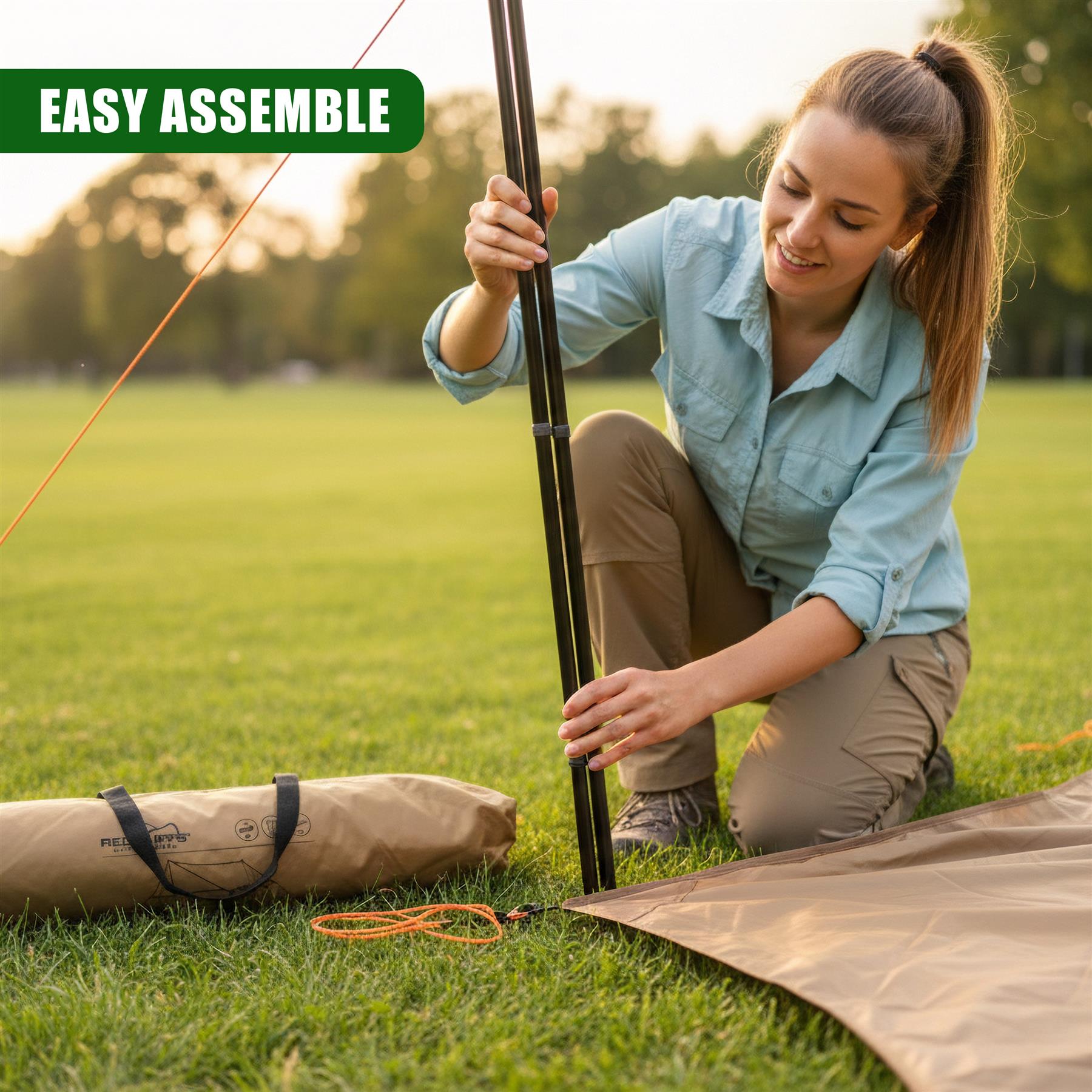 A person handles a pole while the camping tarp and poles are arranged on grass.