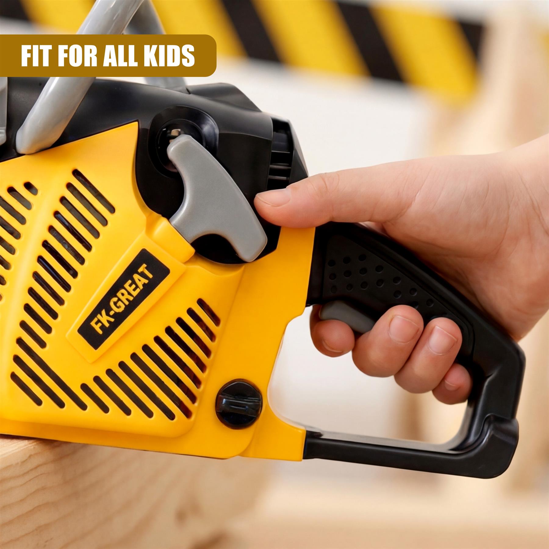 Yellow toy chainsaw with black handle, held by a hand on a light wood surface.